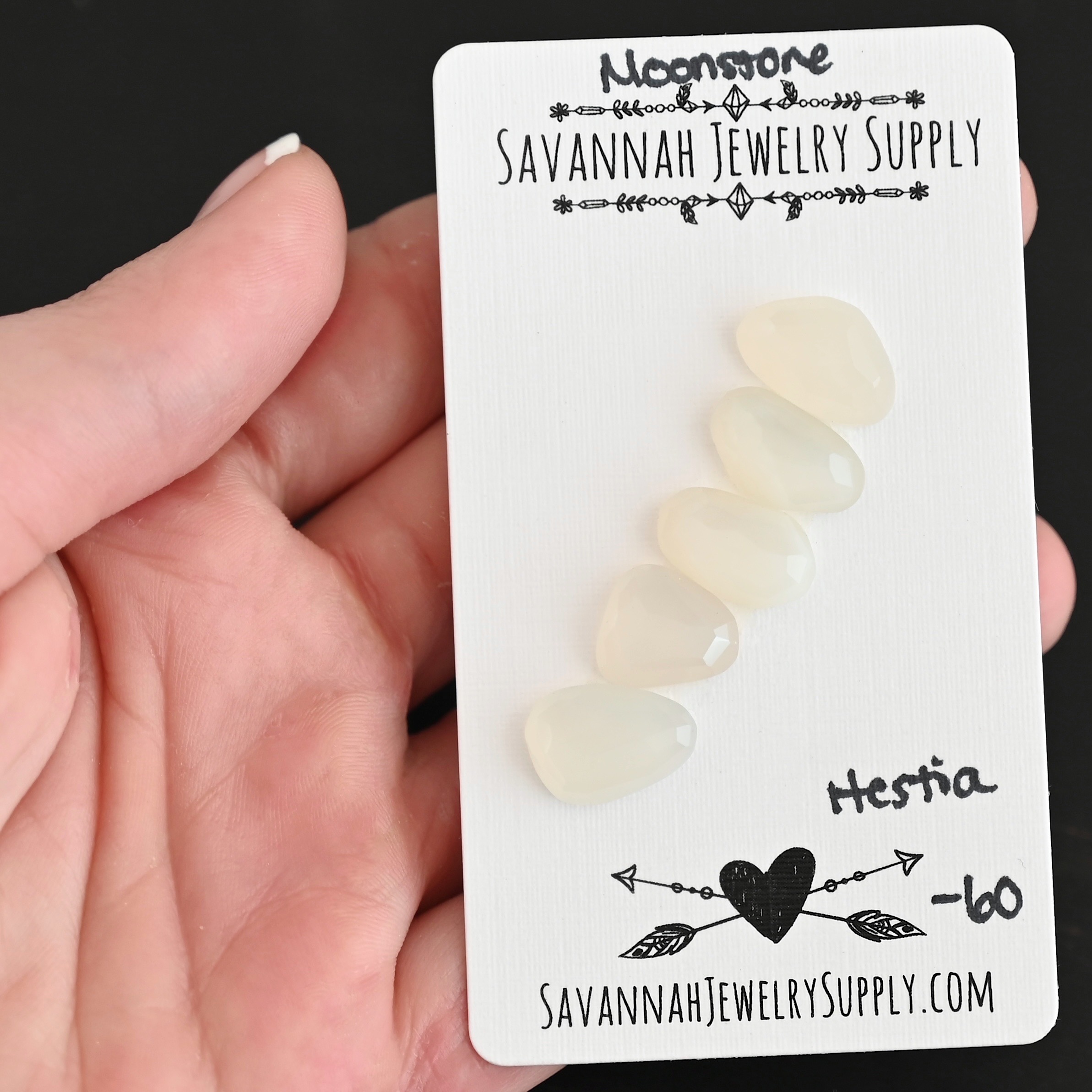 Hestia Rose Cut Moonstone Cabochon Parcel shown in hand