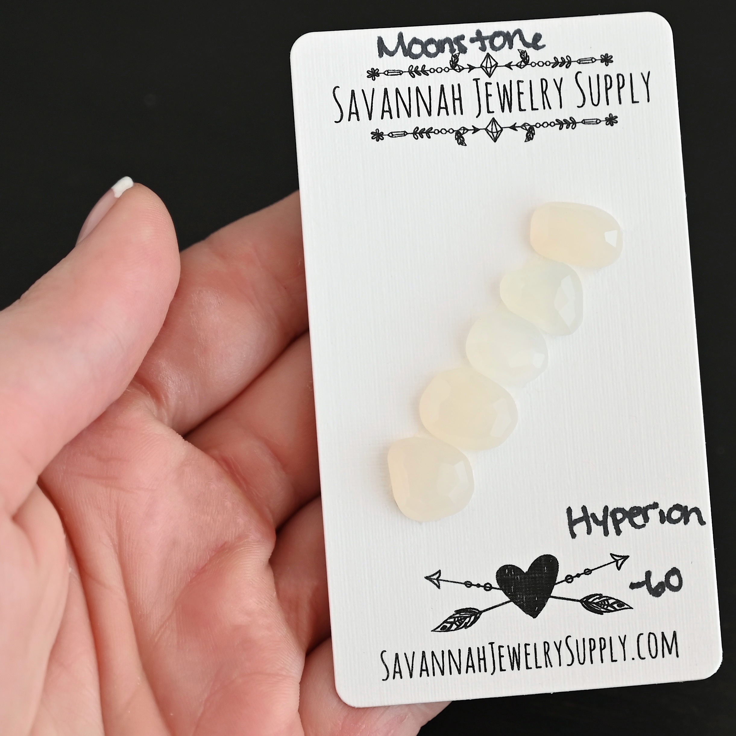 Hypnos Rose Cut Moonstone Cabochon Parcel shown in hand