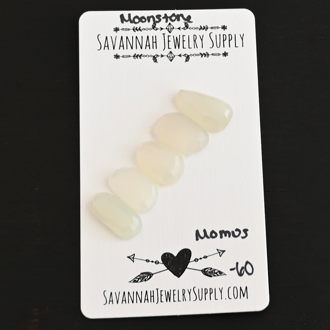 Momus Rose Cut Moonstone Cabochon Parcel shown on business card