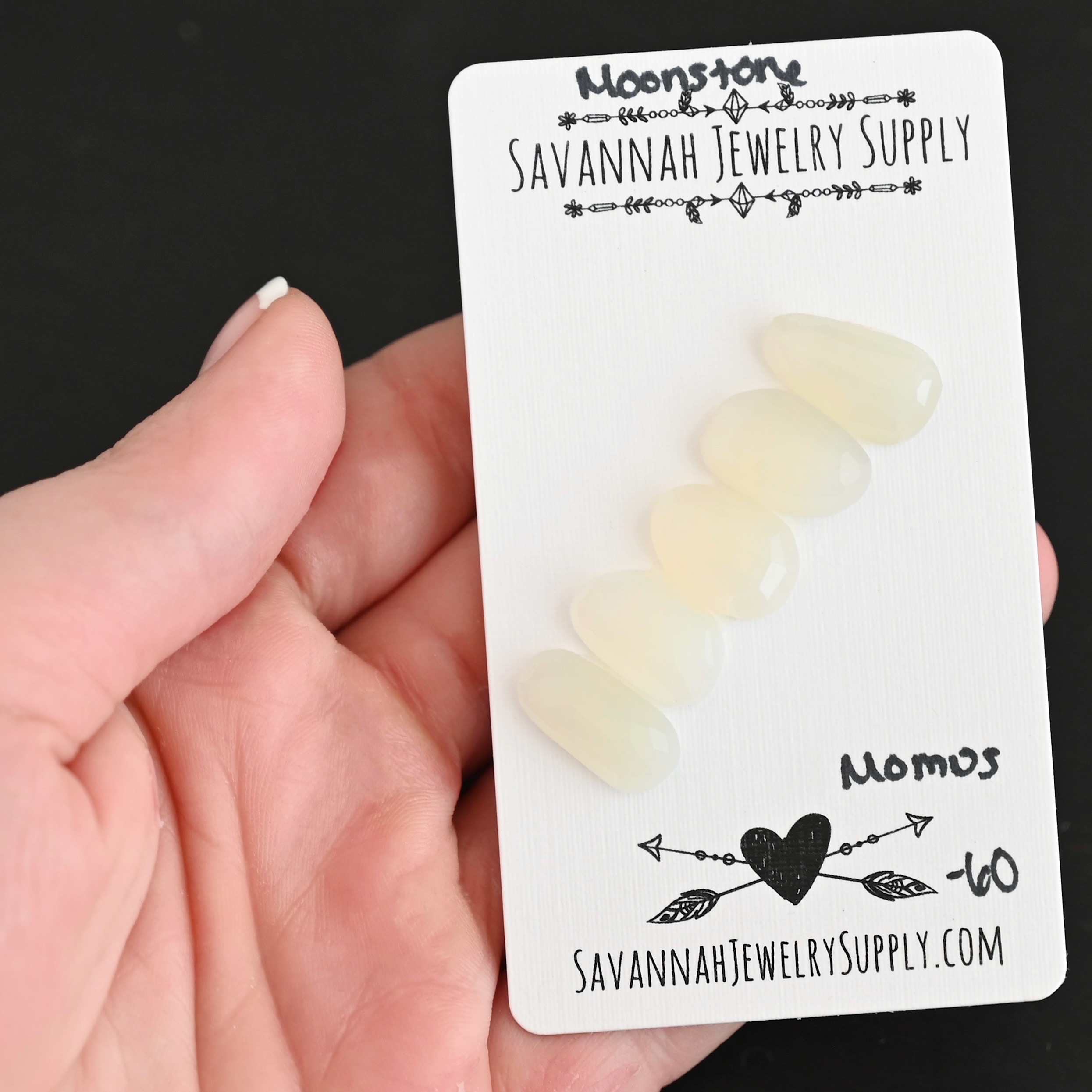 Momus Rose Cut Moonstone Cabochon Parcel shown in hand