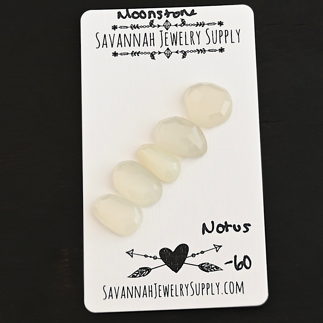 Notus Rose Cut Moonstone Cabochon Parcel shown on business card