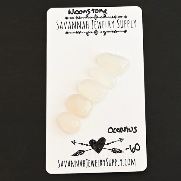 Oceanus Rose Cut Moonstone Cabochon Parcel shown on business card