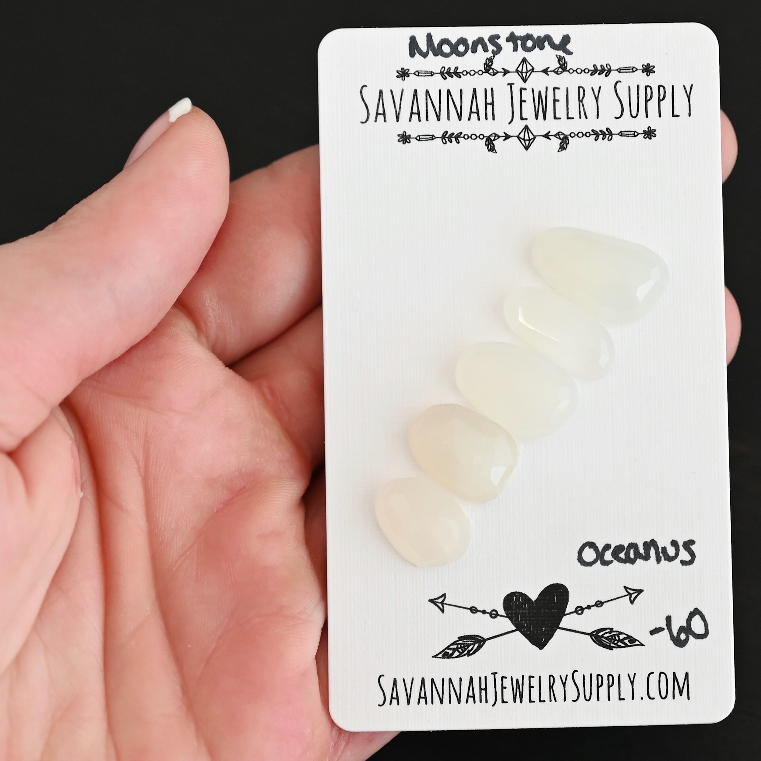 Oceanus Rose Cut Moonstone Cabochon Parcel shown in hand