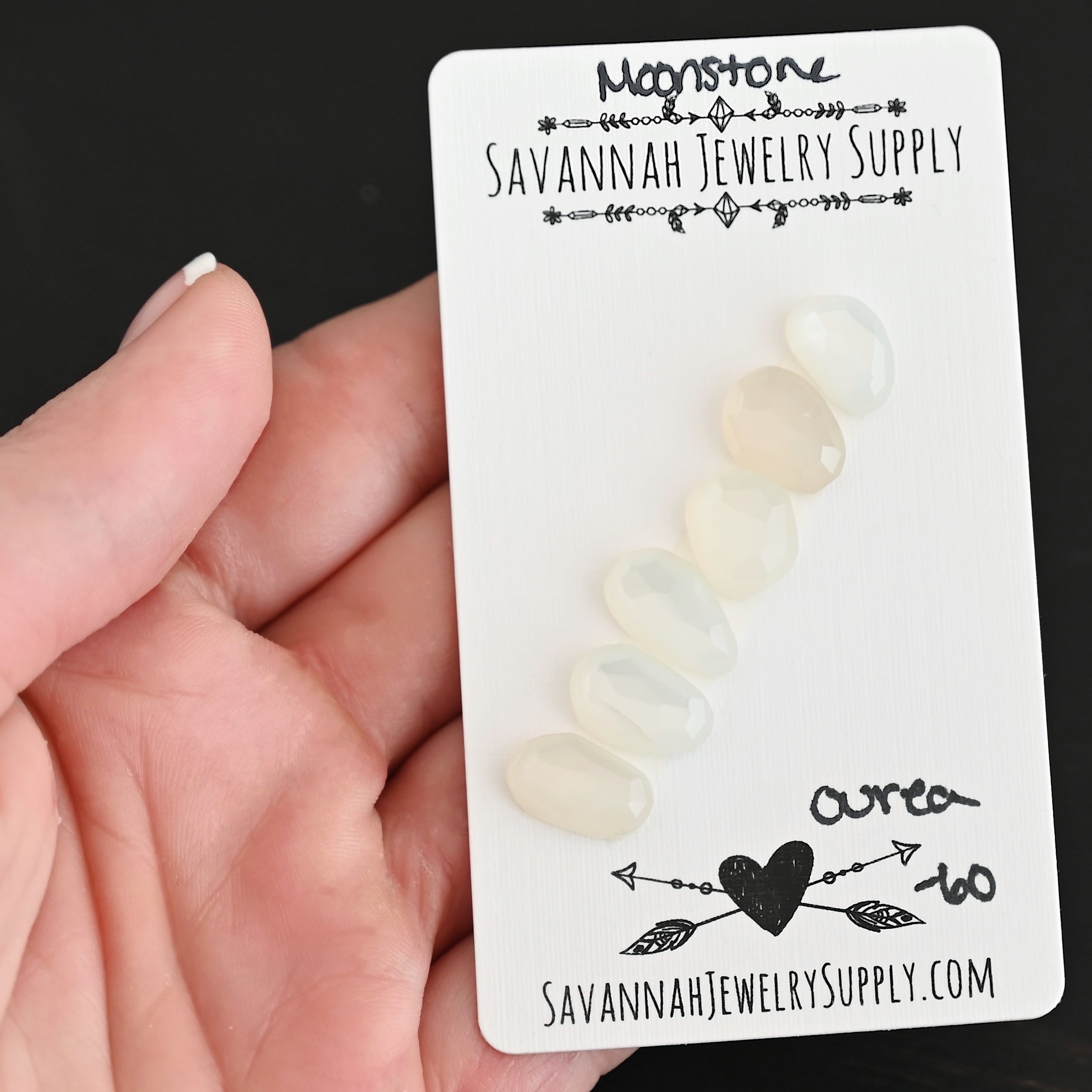 Ourea Rose Cut Moonstone Cabochon Parcel shown in hand