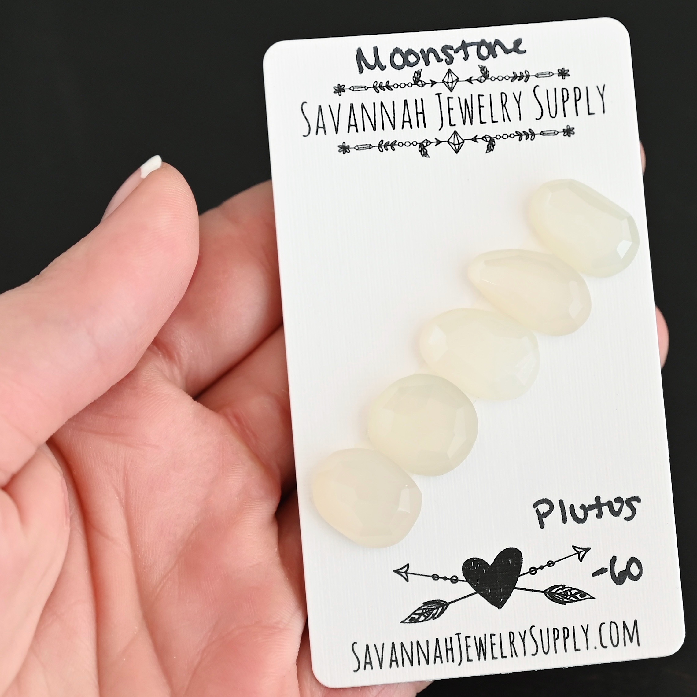 Plutos Rose Cut Moonstone Cabochon Parcel shown in hand