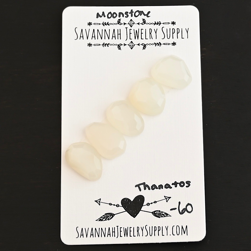 Thanatos Rose Cut Moonstone Cabochon Parcel shown on business card