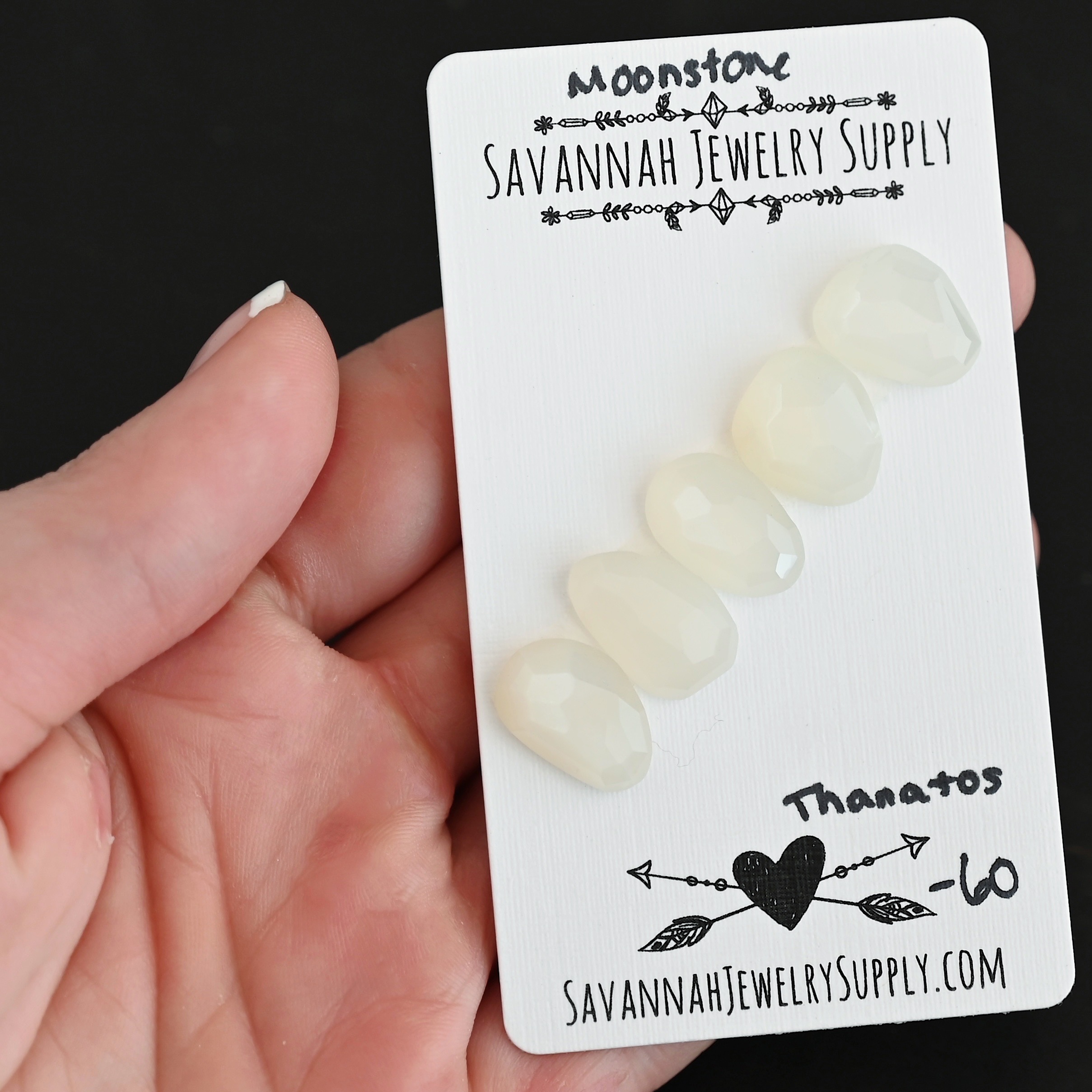 Thanatos Rose Cut Moonstone Cabochon Parcel shown in hand