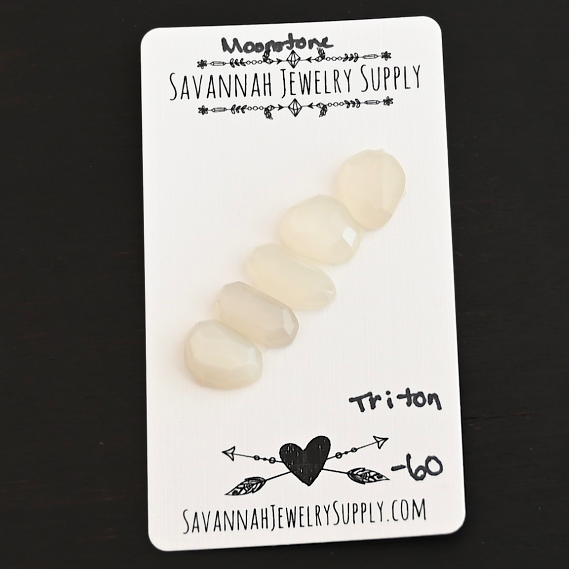 Triton Rose Cut Moonstone Cabochon Parcel shown on business card