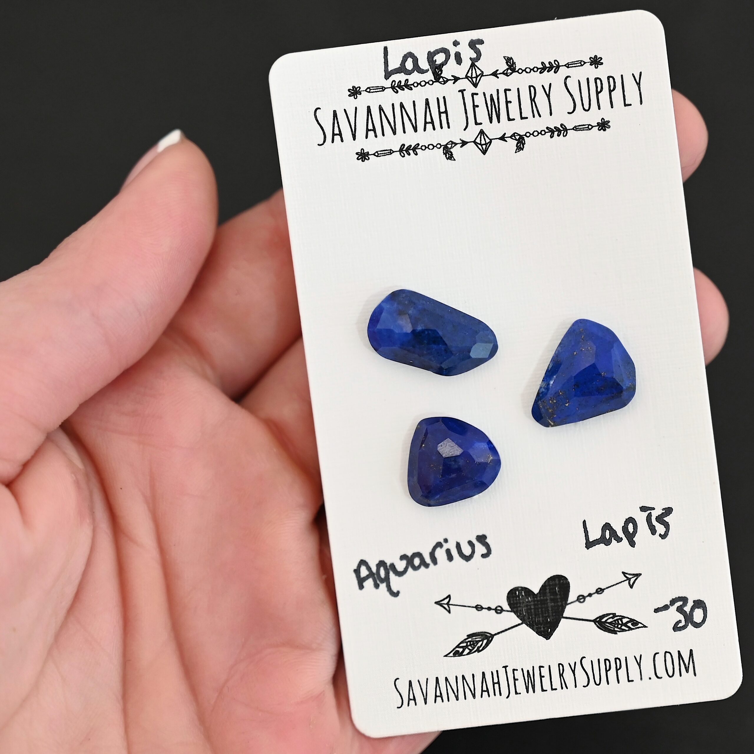 Aquarius Rose Cut Lapis Cabochon Parcel shown in hand