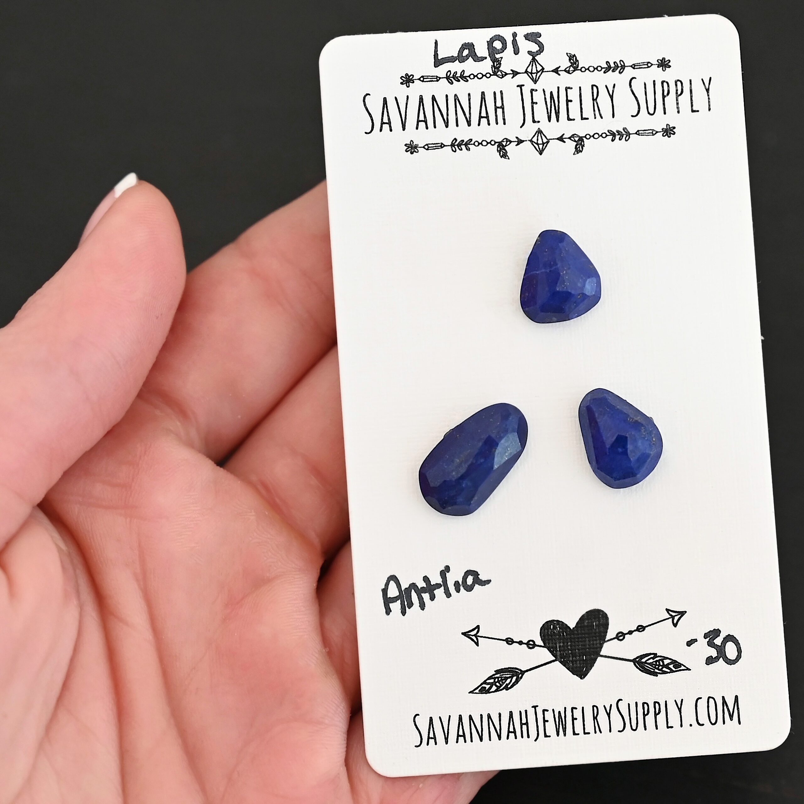 Antlia Rose Cut Lapis Cabochon Parcel shown in hand