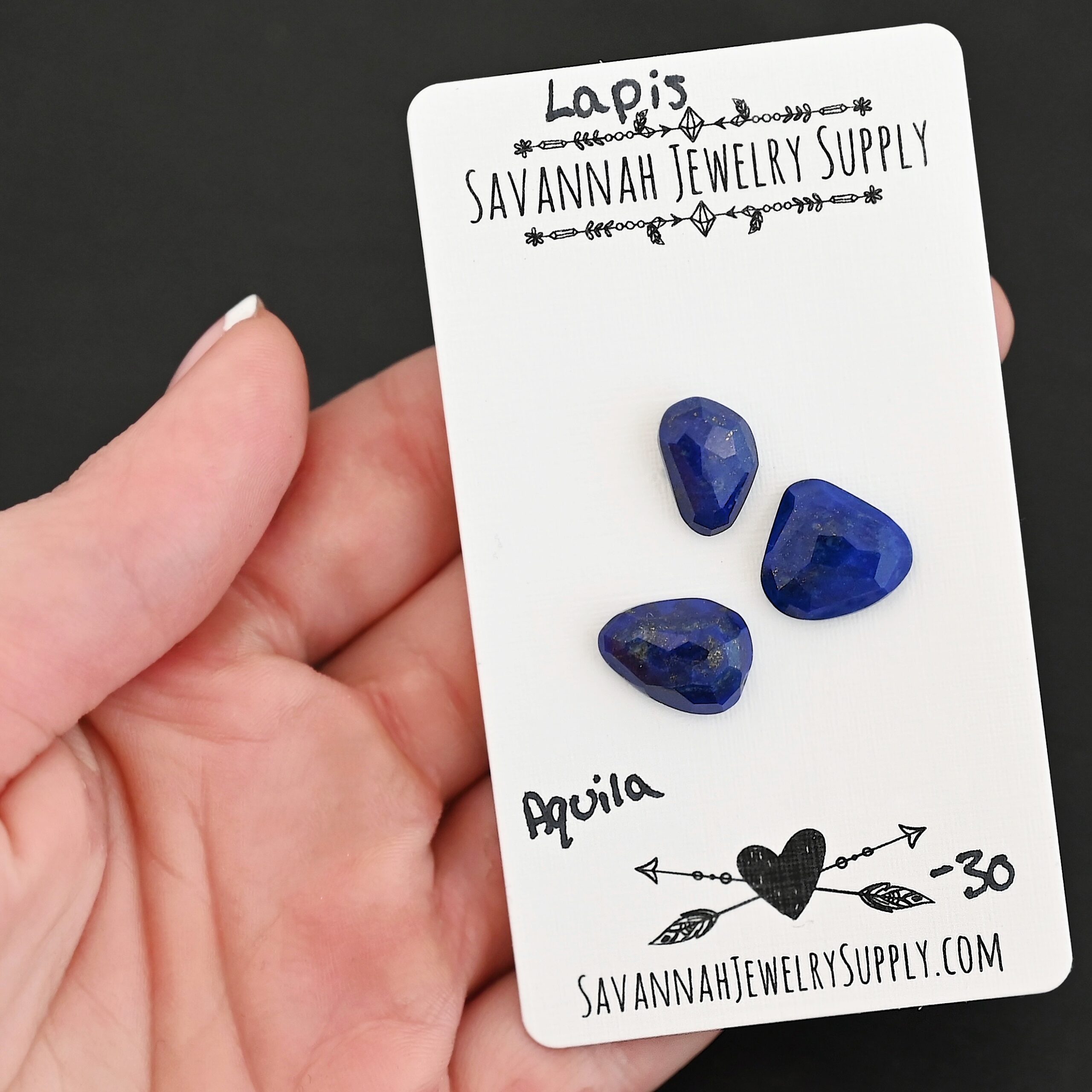 Aquila Rose Cut Lapis Cabochon Parcel shown in hand