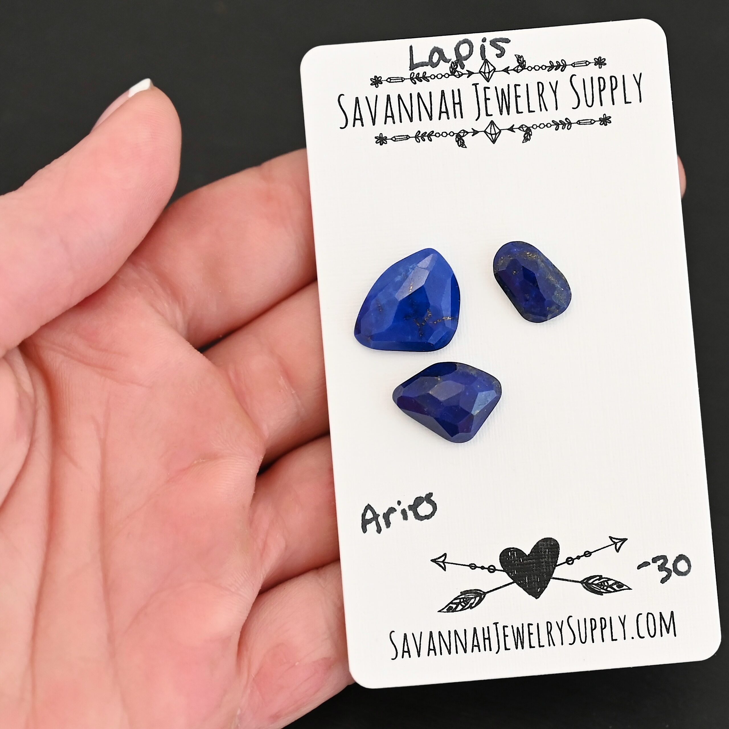 Aries Rose Cut Lapis Cabochon Parcel shown in hand