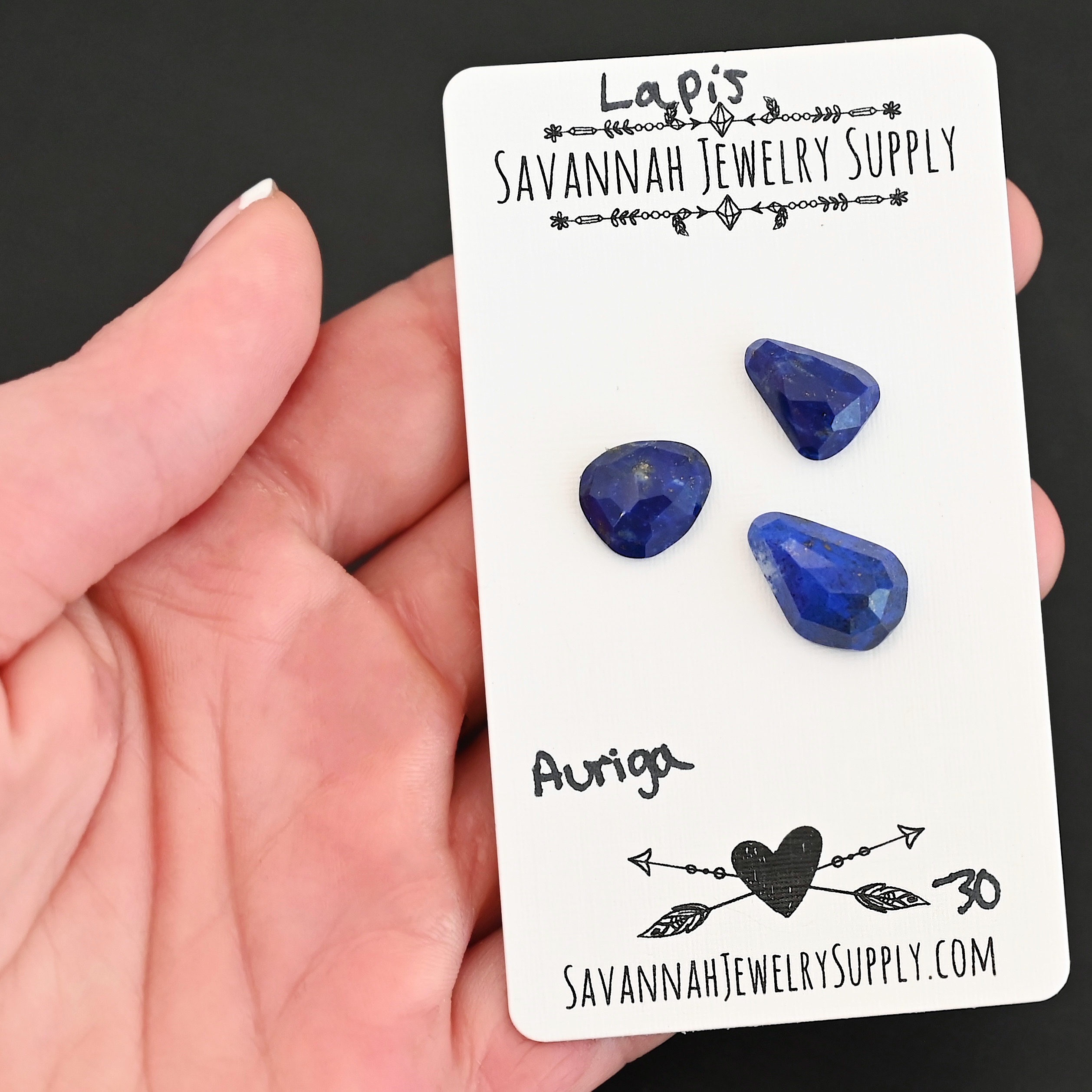 Auriga Rose Cut Lapis Cabochon Parcel shown in hand