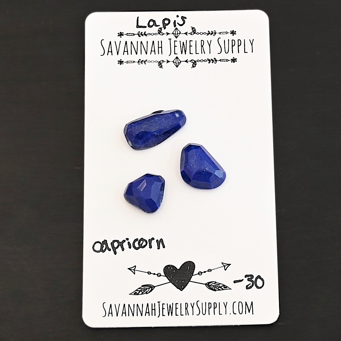 Capricorn Rose Cut Lapis Cabochon Parcel shown on business card