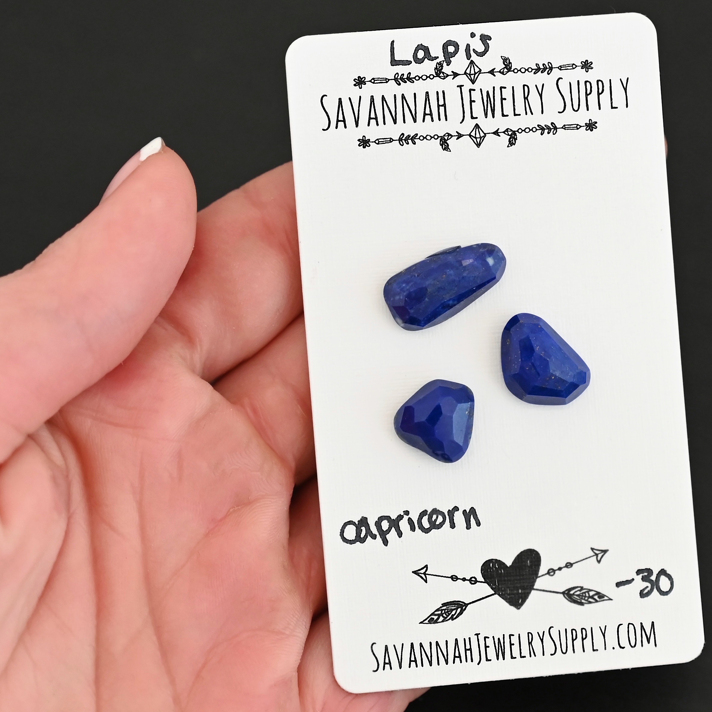 Capricorn Rose Cut Lapis Cabochon Parcel shown in hand