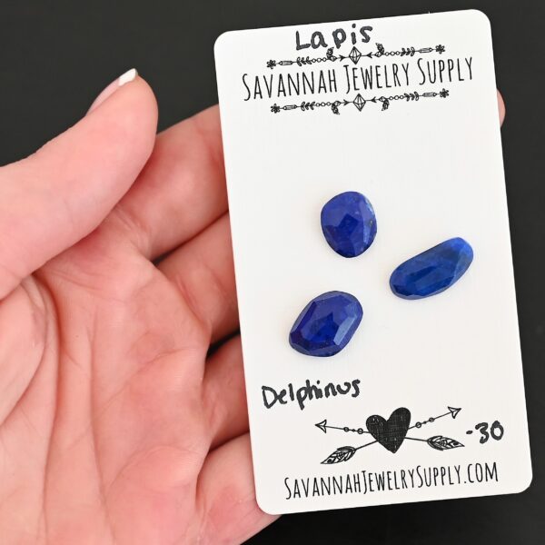 Delphinus Rose Cut Lapis Cabochon Parcel shown in hand