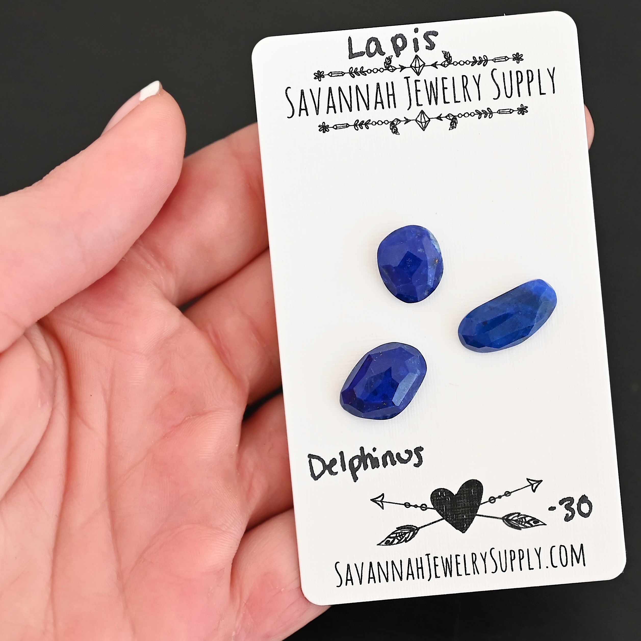 Delphinus Rose Cut Lapis Cabochon Parcel shown in hand