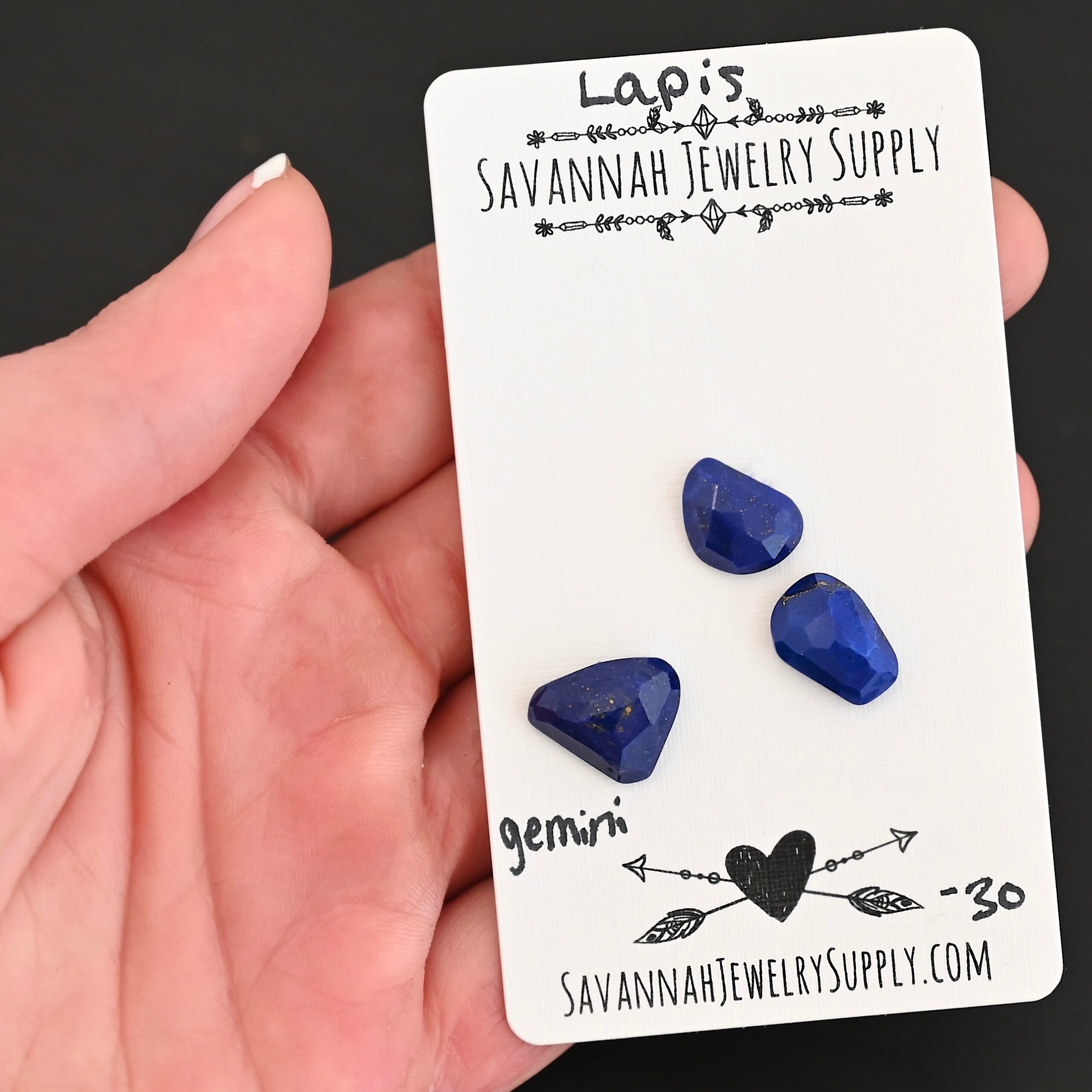Gemini Rose Cut Lapis Cabochon Parcel shown in hand