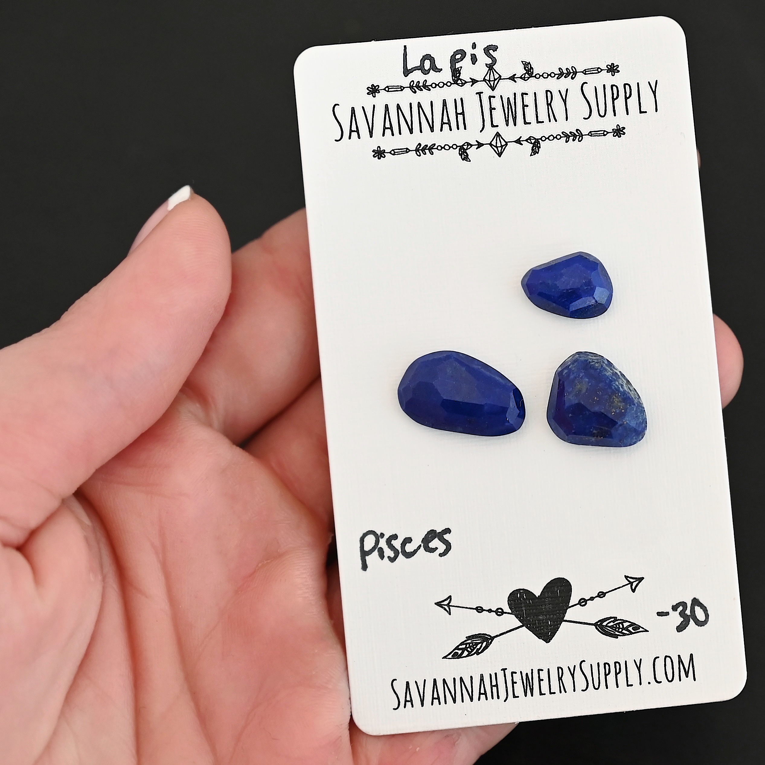 Pisces Rose Cut Lapis Cabochon Parcel shown in hand