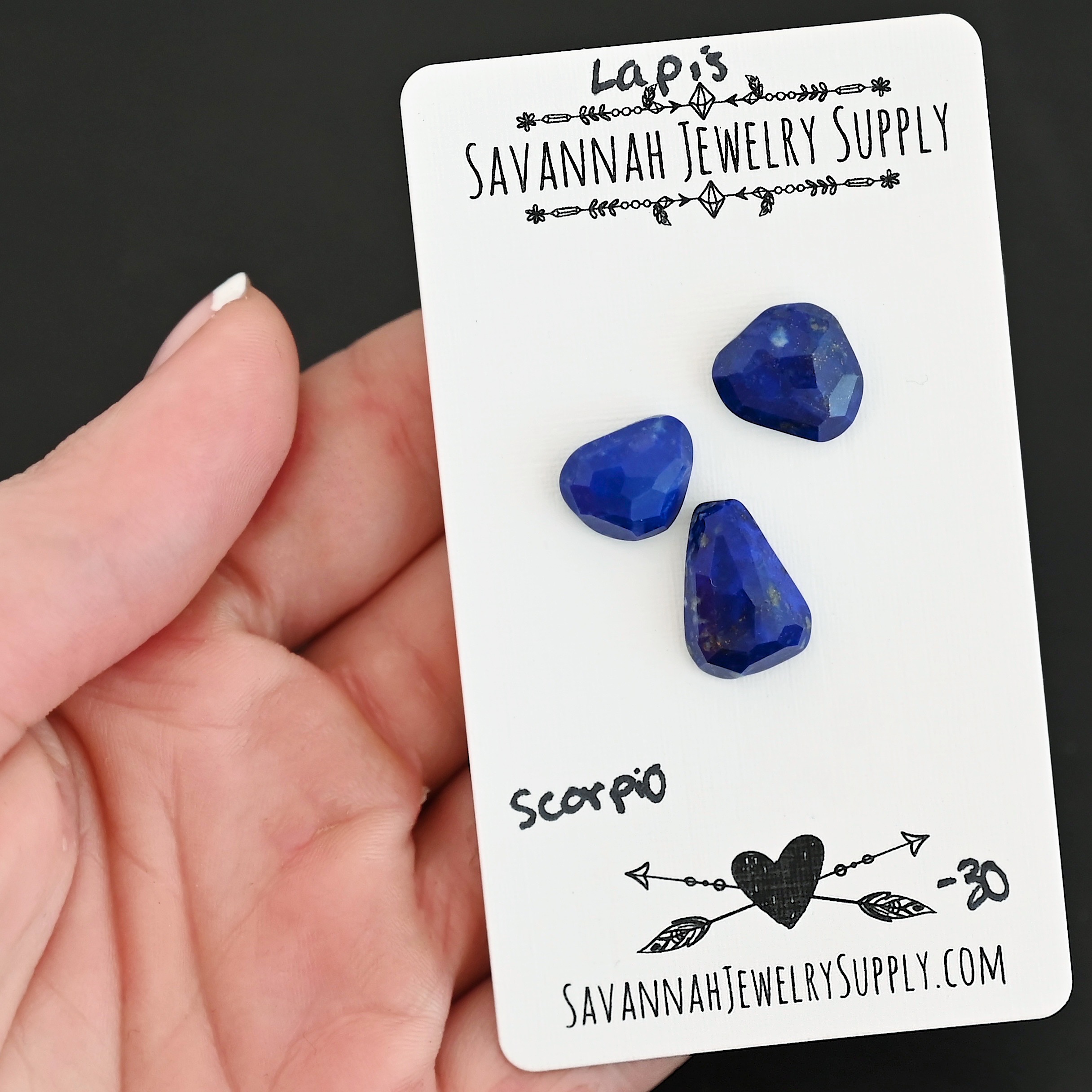 Scorpio Rose Cut Lapis Cabochon Parcel shown in hand
