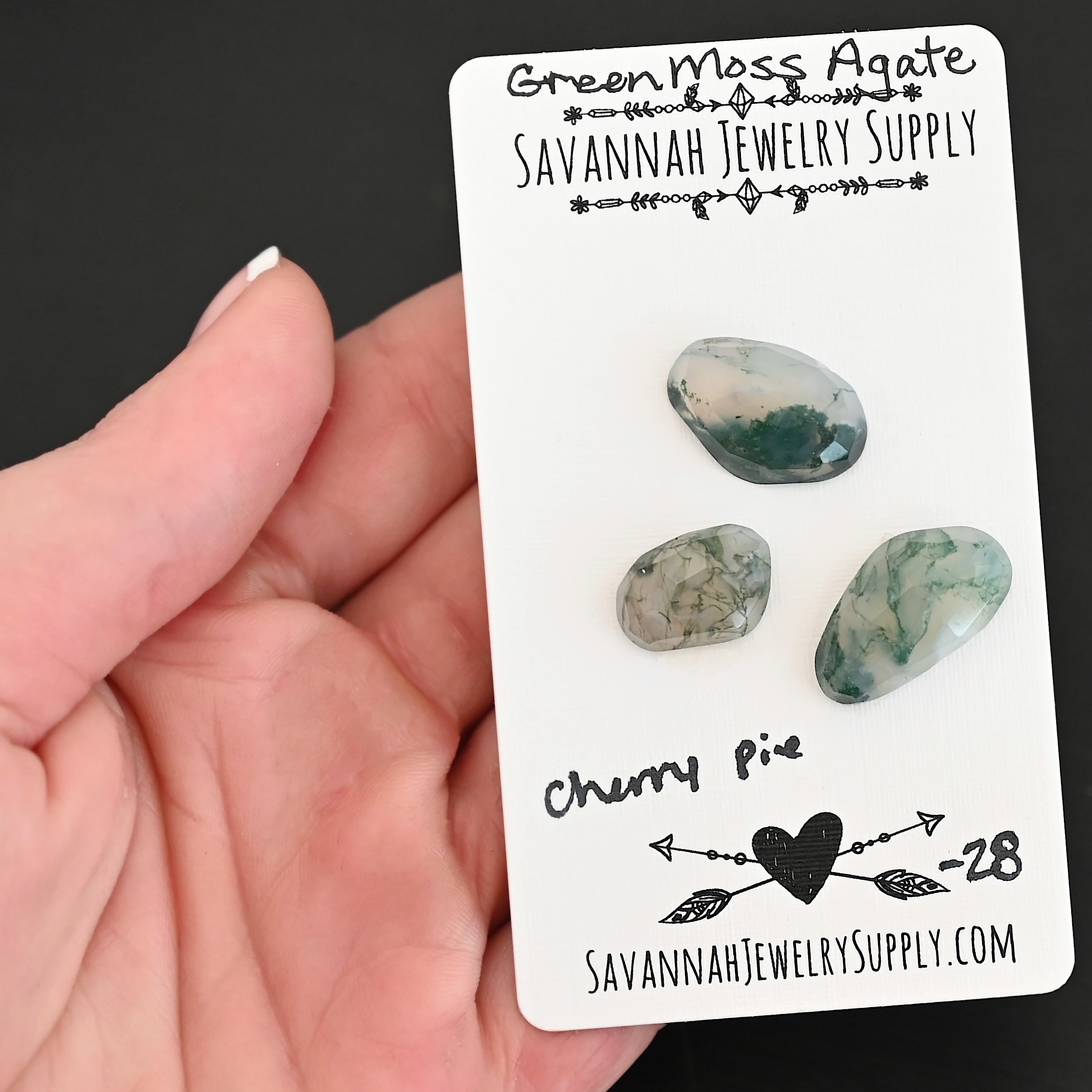 Cherry Pie Rose Cut Green Moss Agate Cabochon Parcel shown in hand