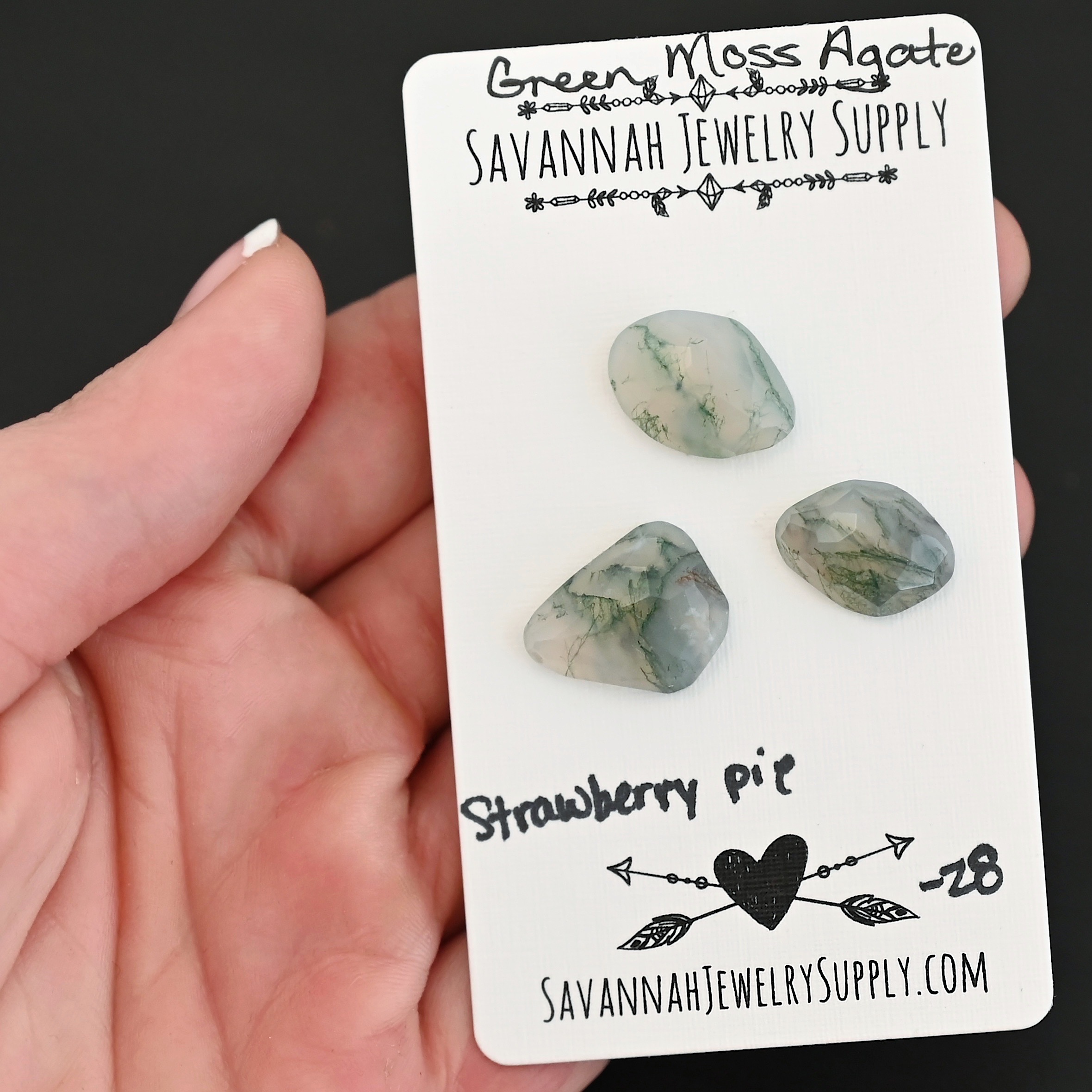 Strawberry Pie Rose Cut Green Moss Agate Cabochon Parcel shown in hand