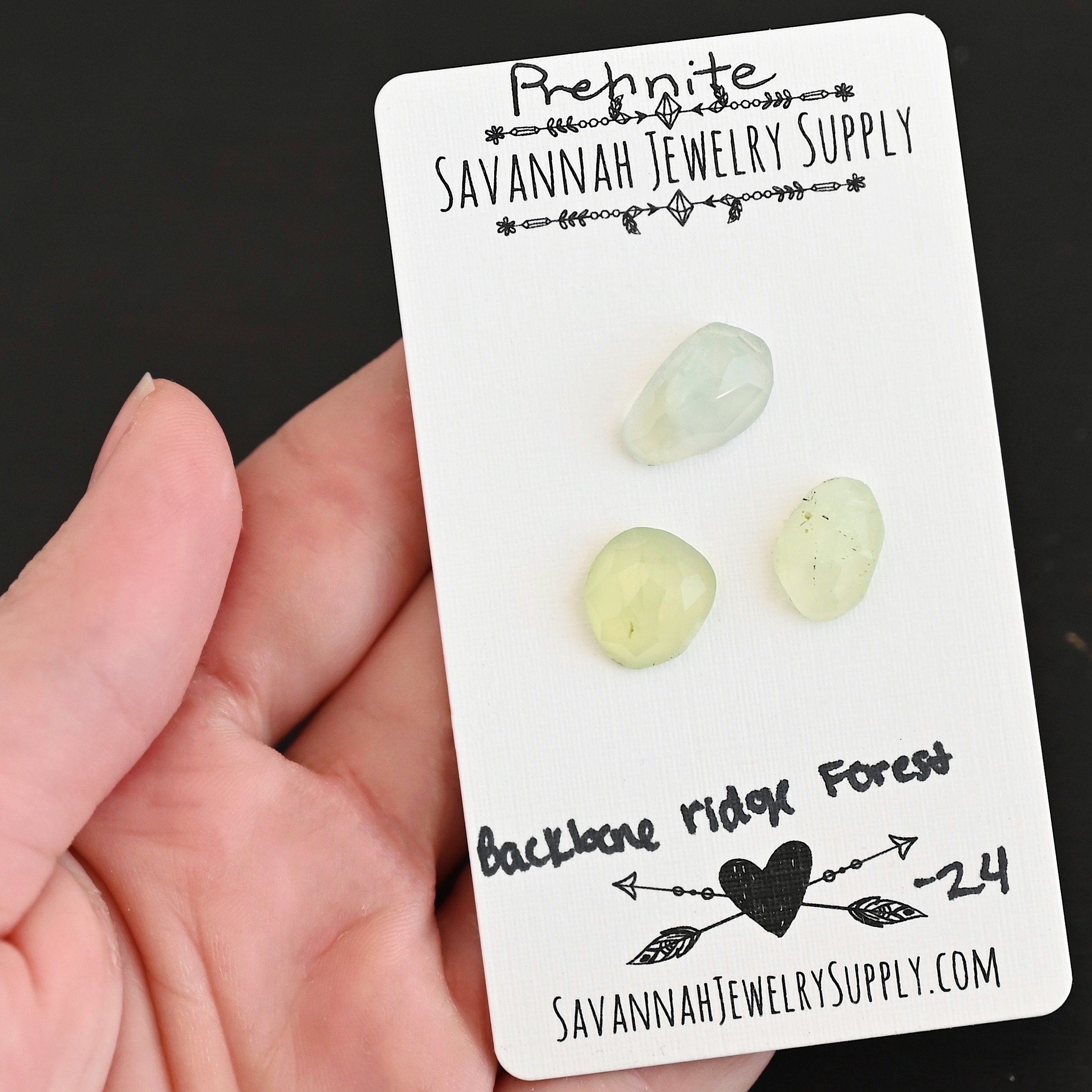 Backbone Forest Rose Cut Prehnite Cabochon Parcel shown in hand