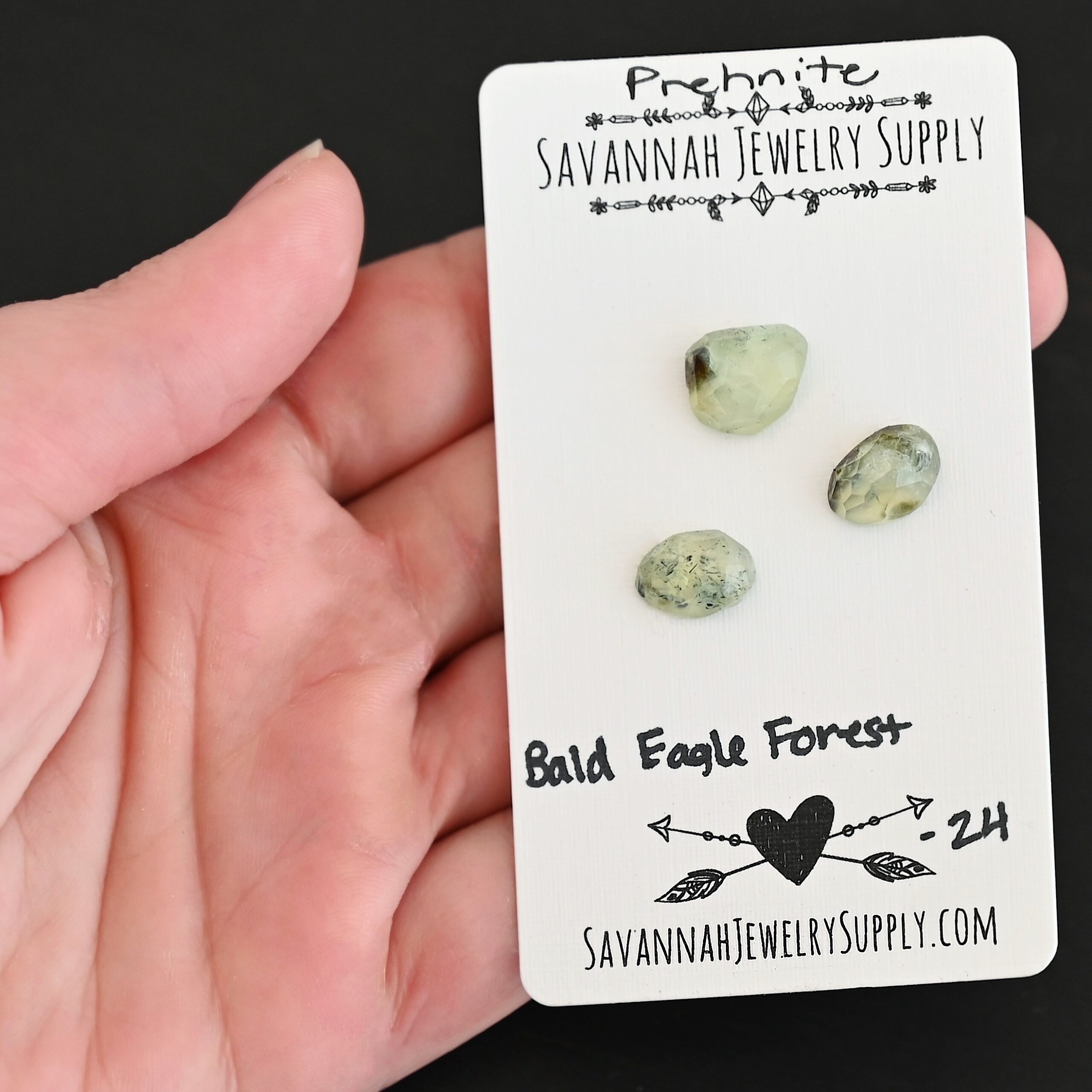 Bald Eagle Forest Rose Cut Prehnite Cabochon Parcel shown in hand