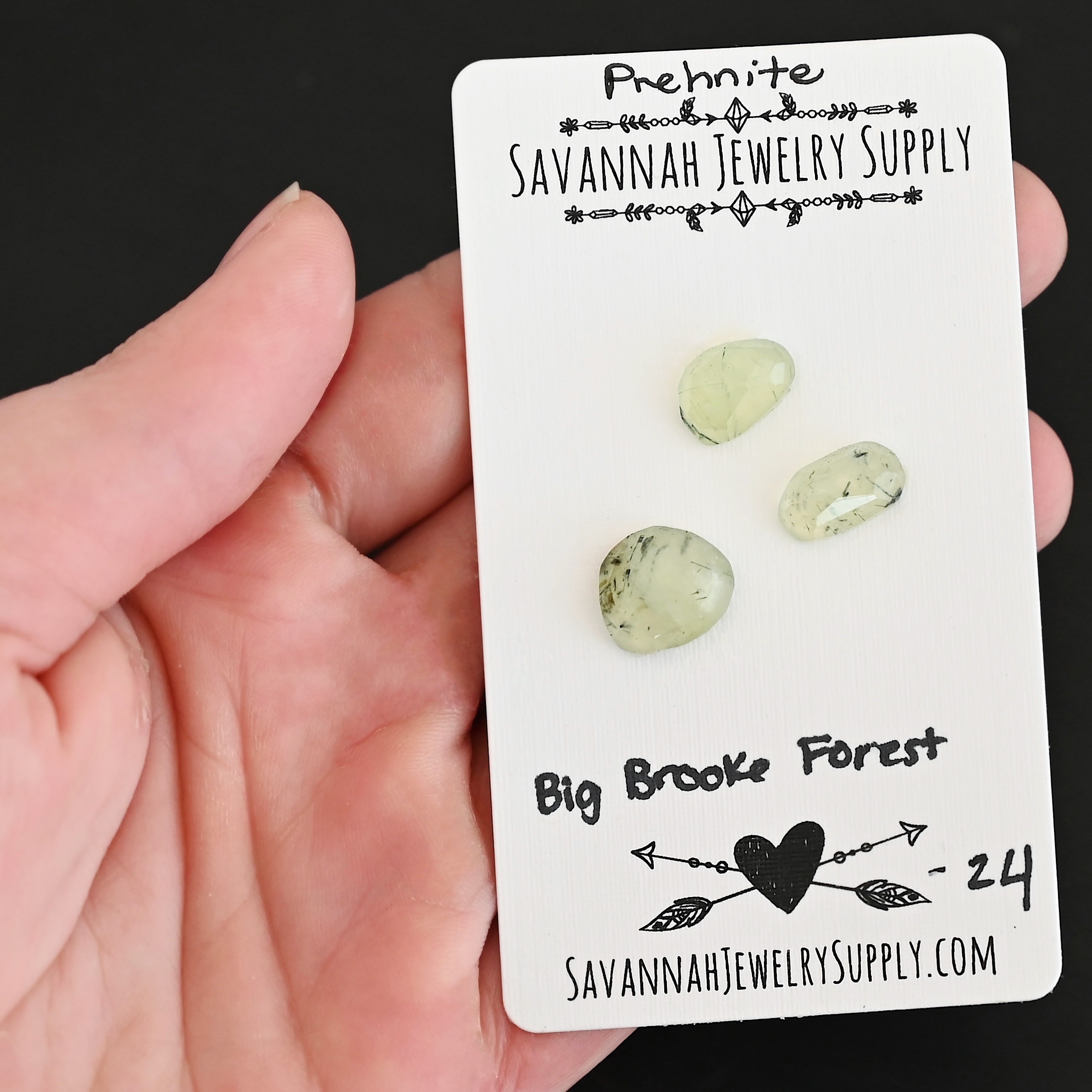 Big Brook Forest Rose Cut Prehnite Cabochon Parcel shown in hand