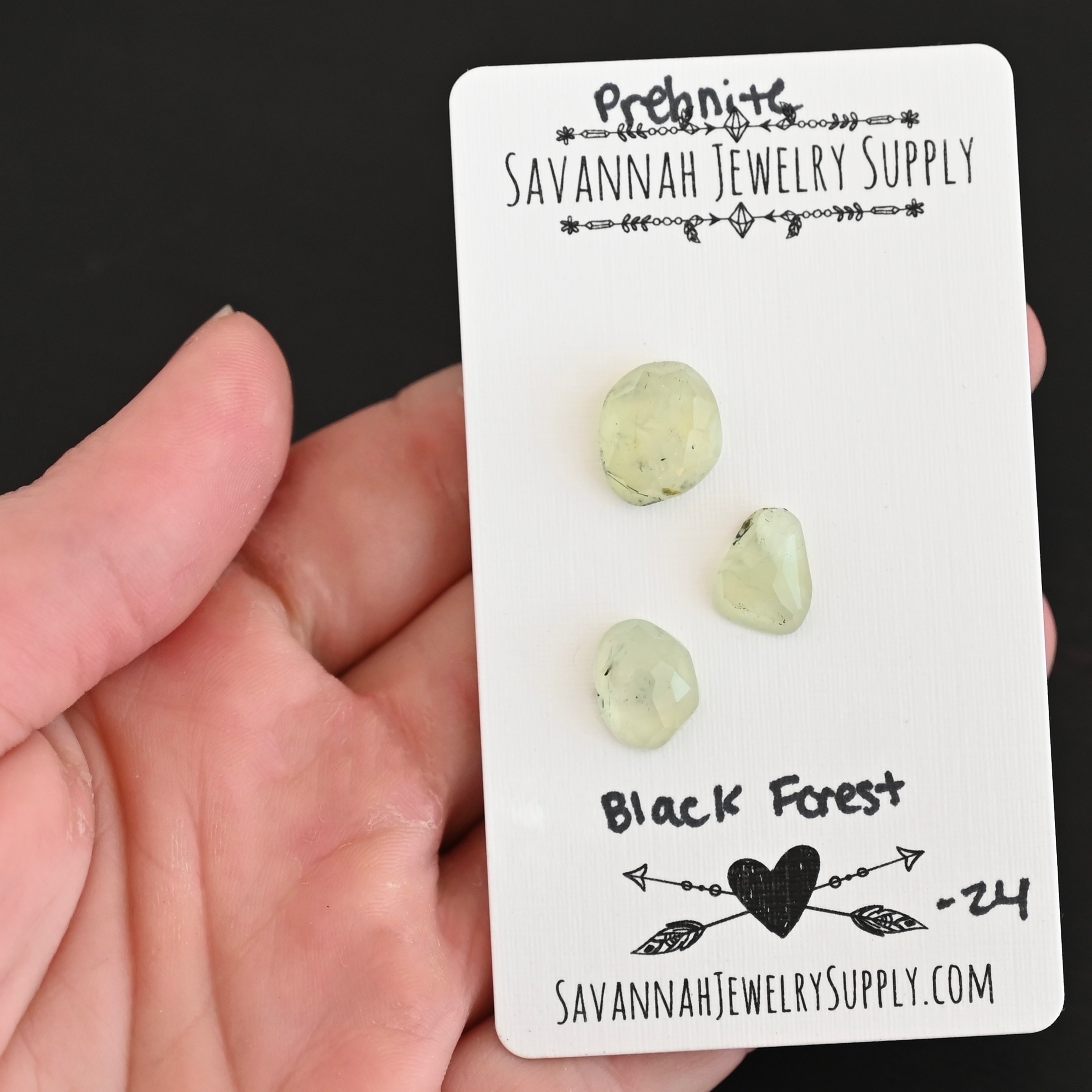 Black Forest Rose Cut Prehnite Cabochon Parcel shown in hand