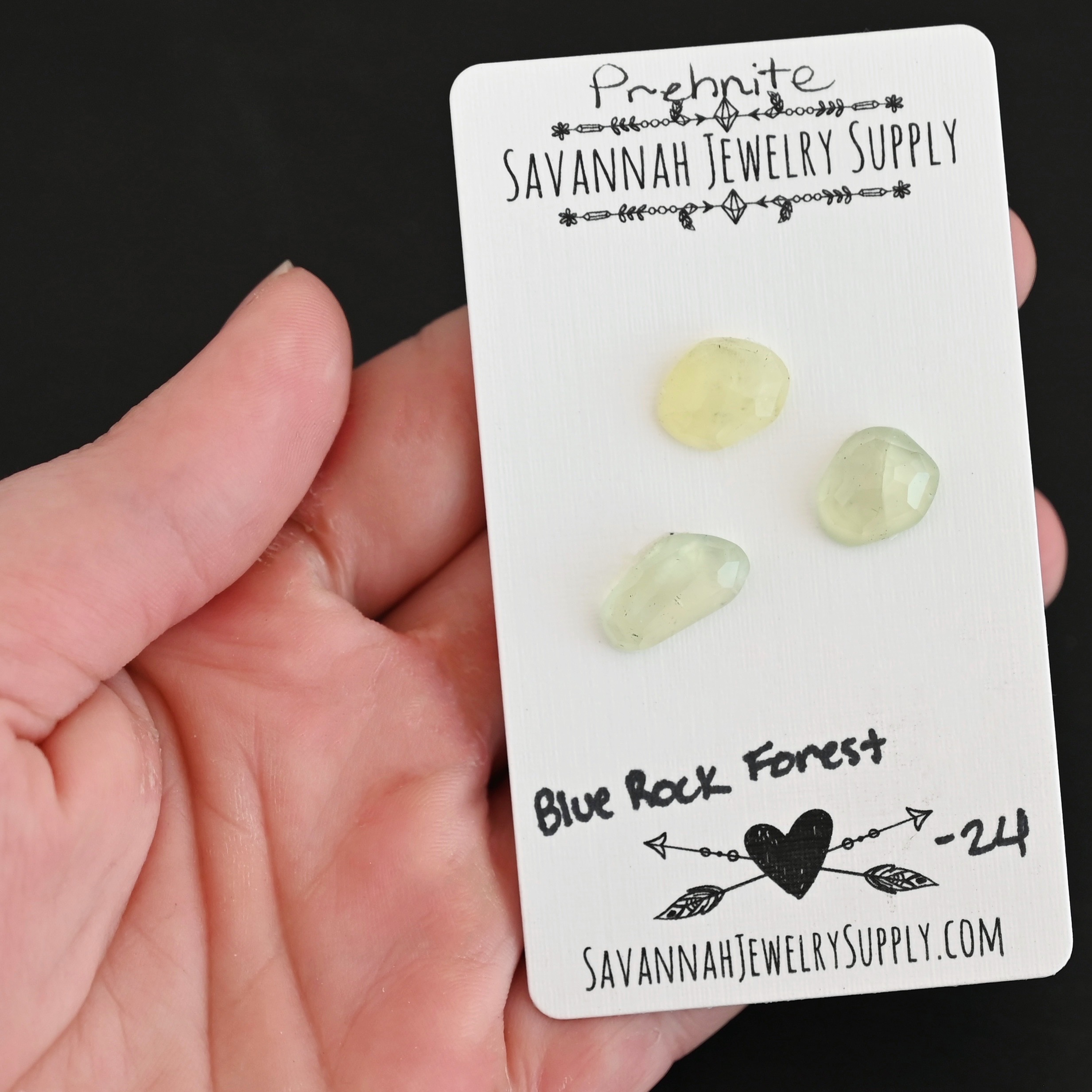 Blue Rock Forest Rose Cut Prehnite Cabochon Parcel shown in hand
