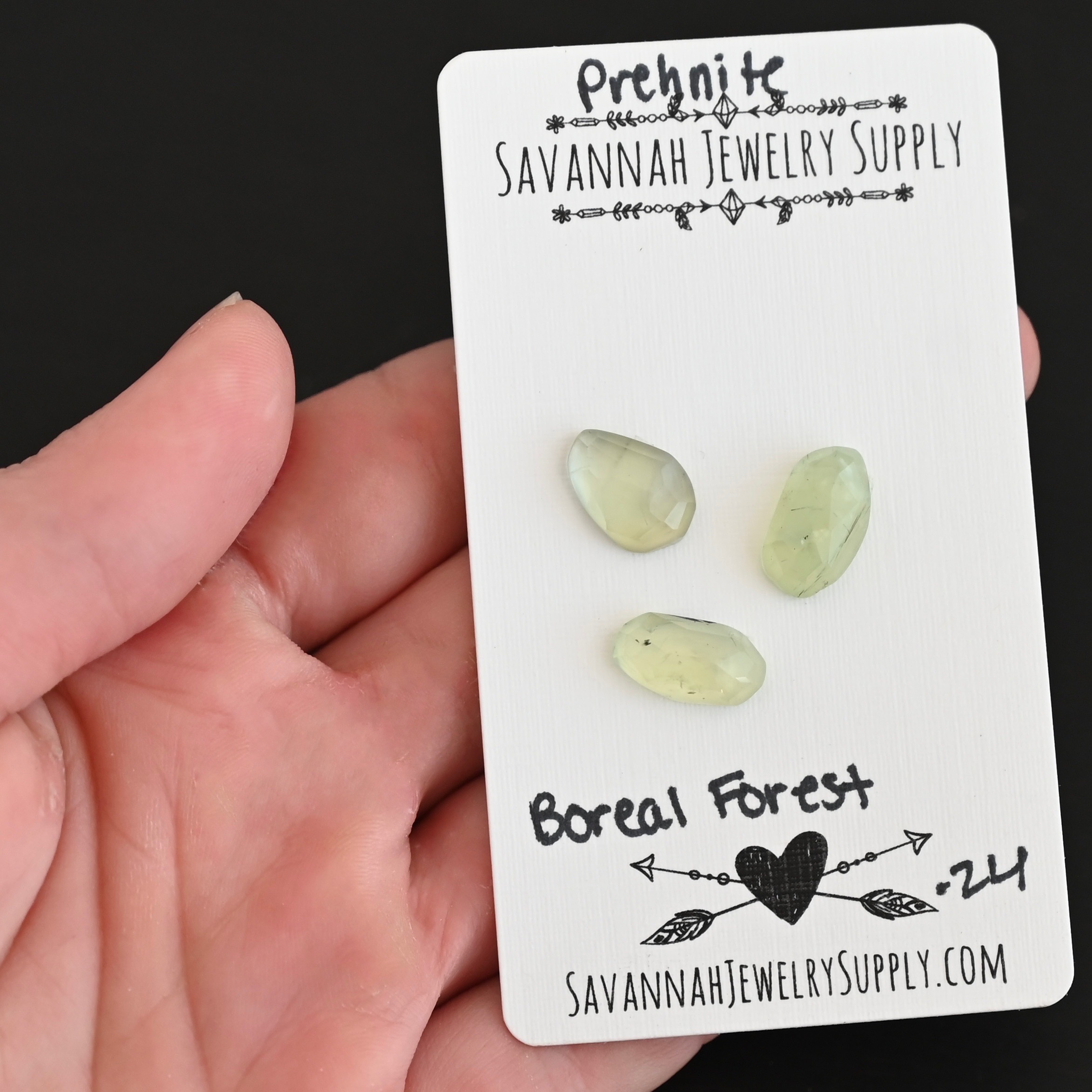Boreal Forest Rose Cut Prehnite Cabochon Parcel shown in hand
