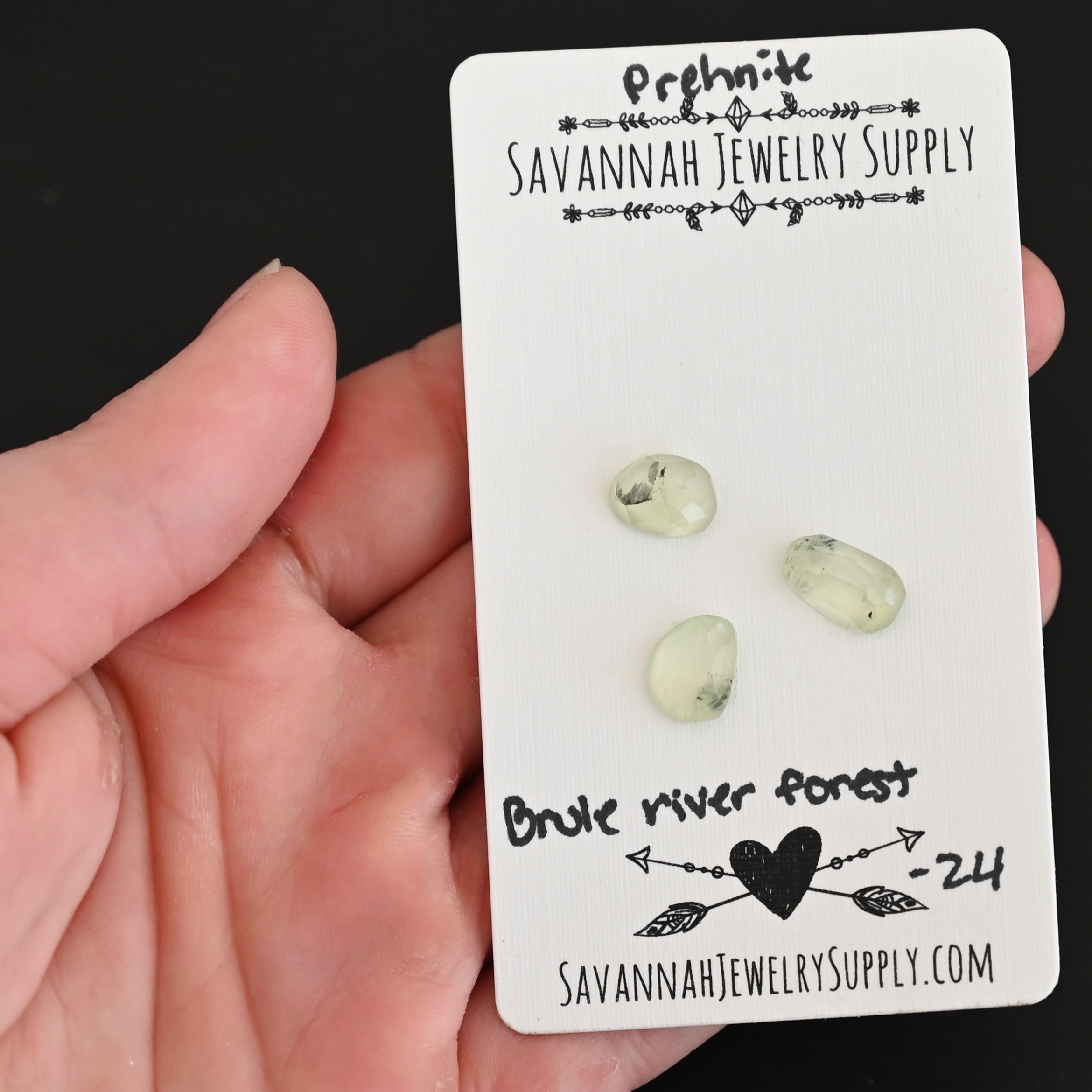 Brule River State Forest Rose Cut Prehnite Cabochon Parcel shown in hand