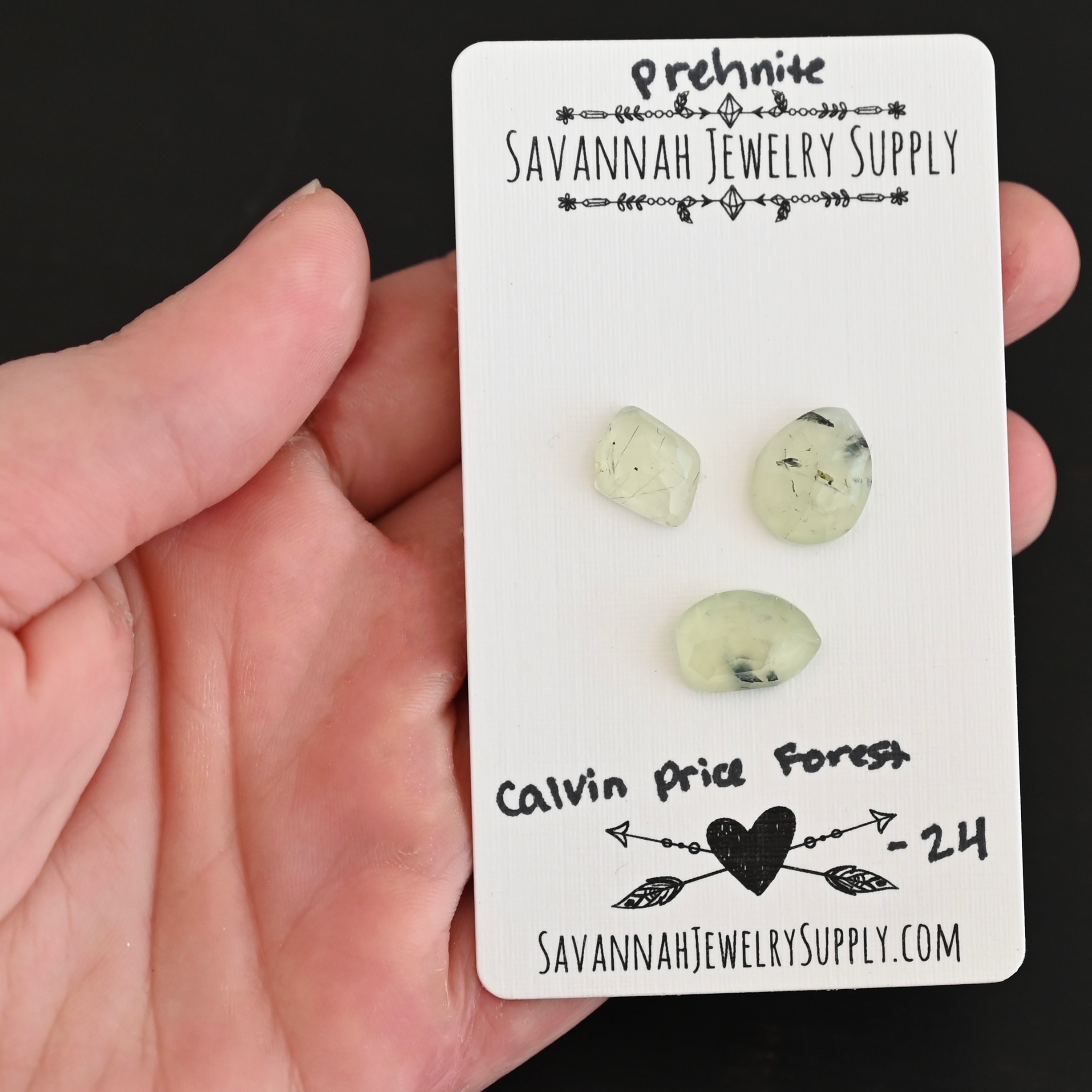 Calvin Price Forest Rose Cut Prehnite Cabochon Parcel shown in hand