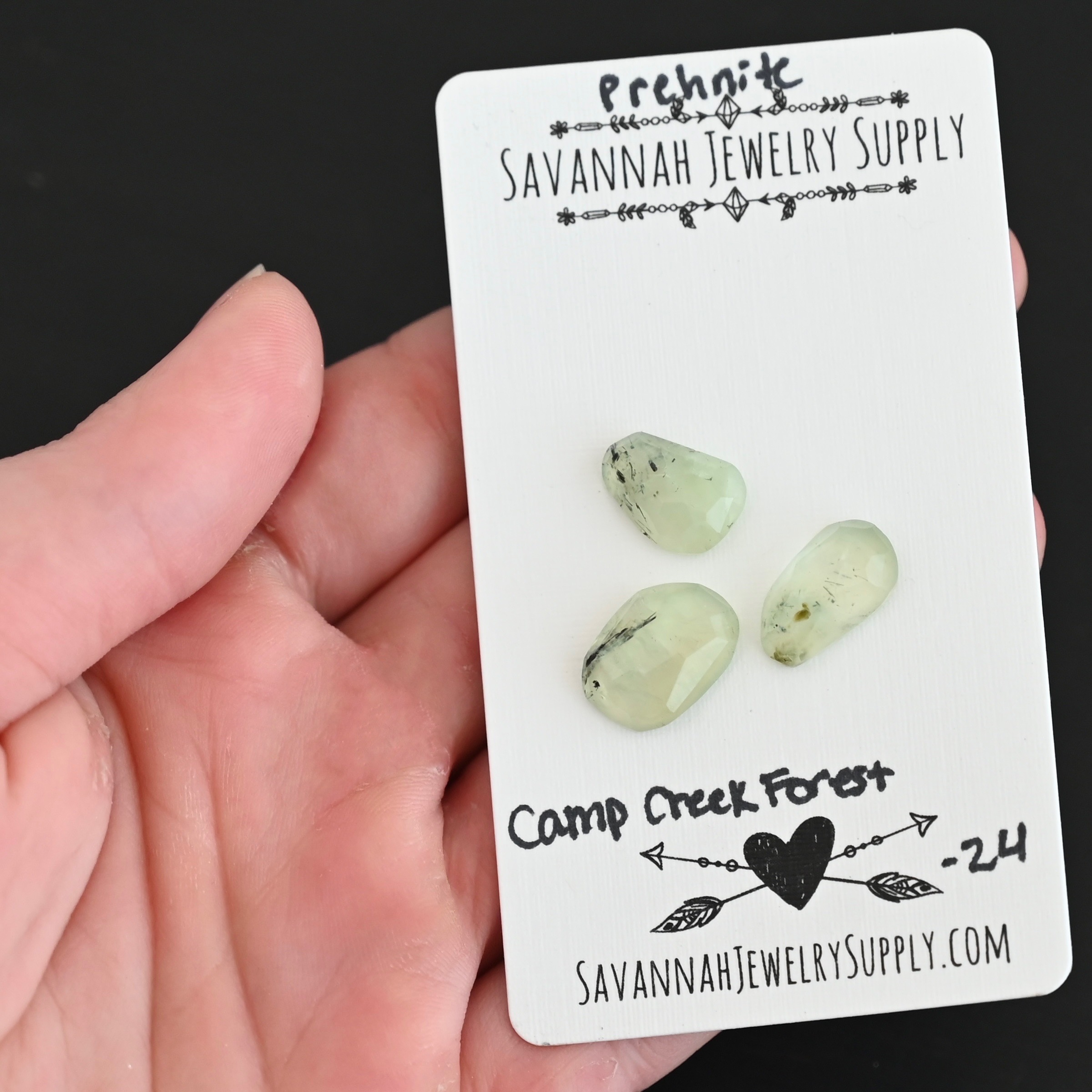 Camp Creek Forest Rose Cut Prehnite Cabochon Parcel shown in hand