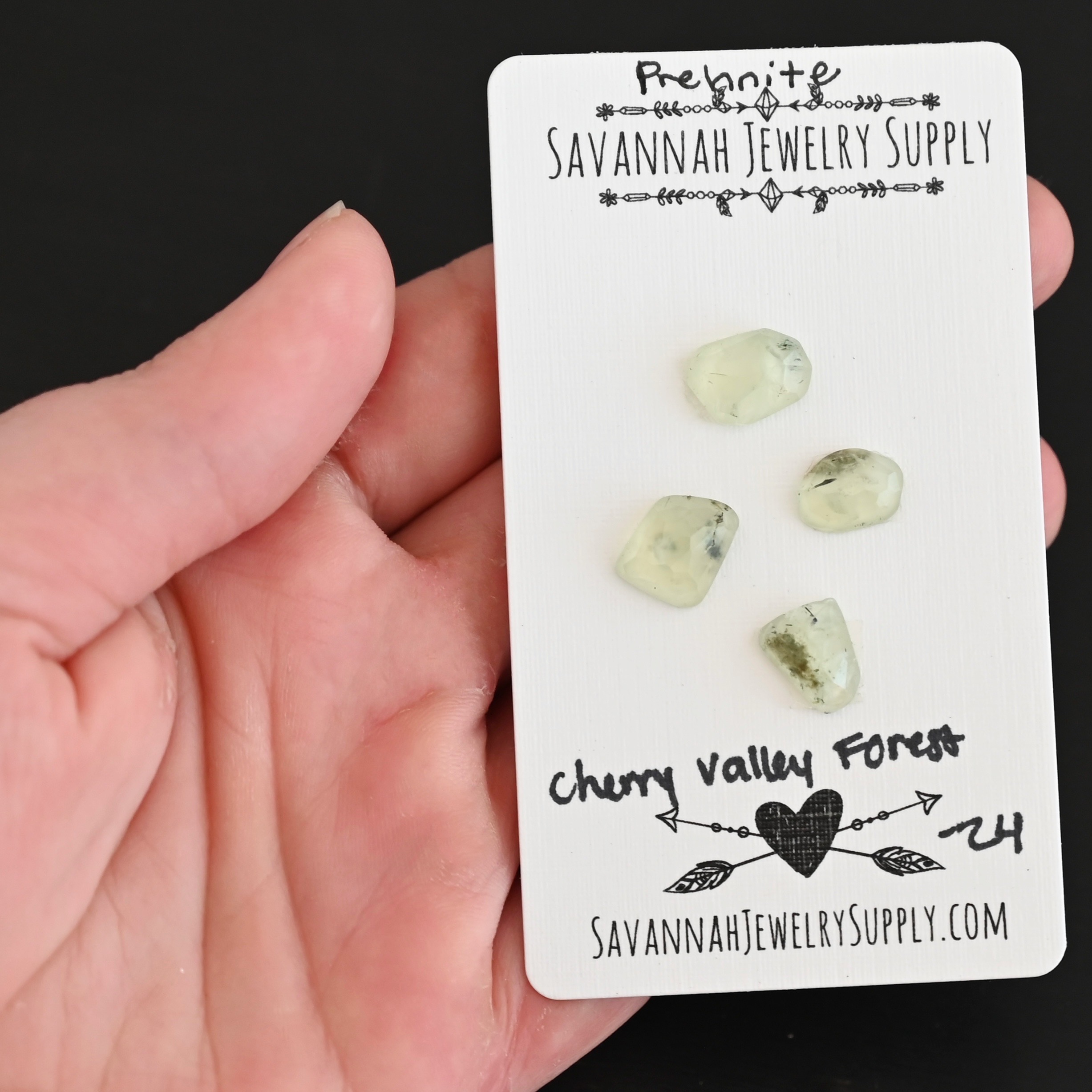 Cherry Valley Forest Rose Cut Prehnite Cabochon Parcel shown in hand