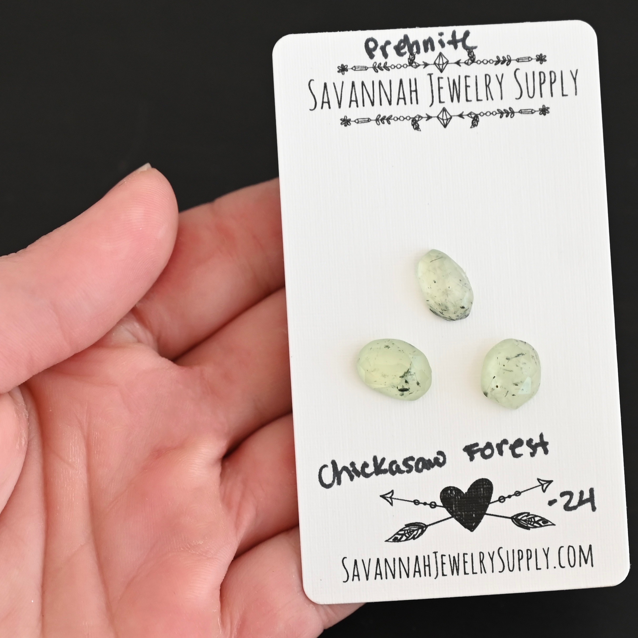 Chickasaw Forest Rose Cut Prehnite Cabochon Parcel shown in hand