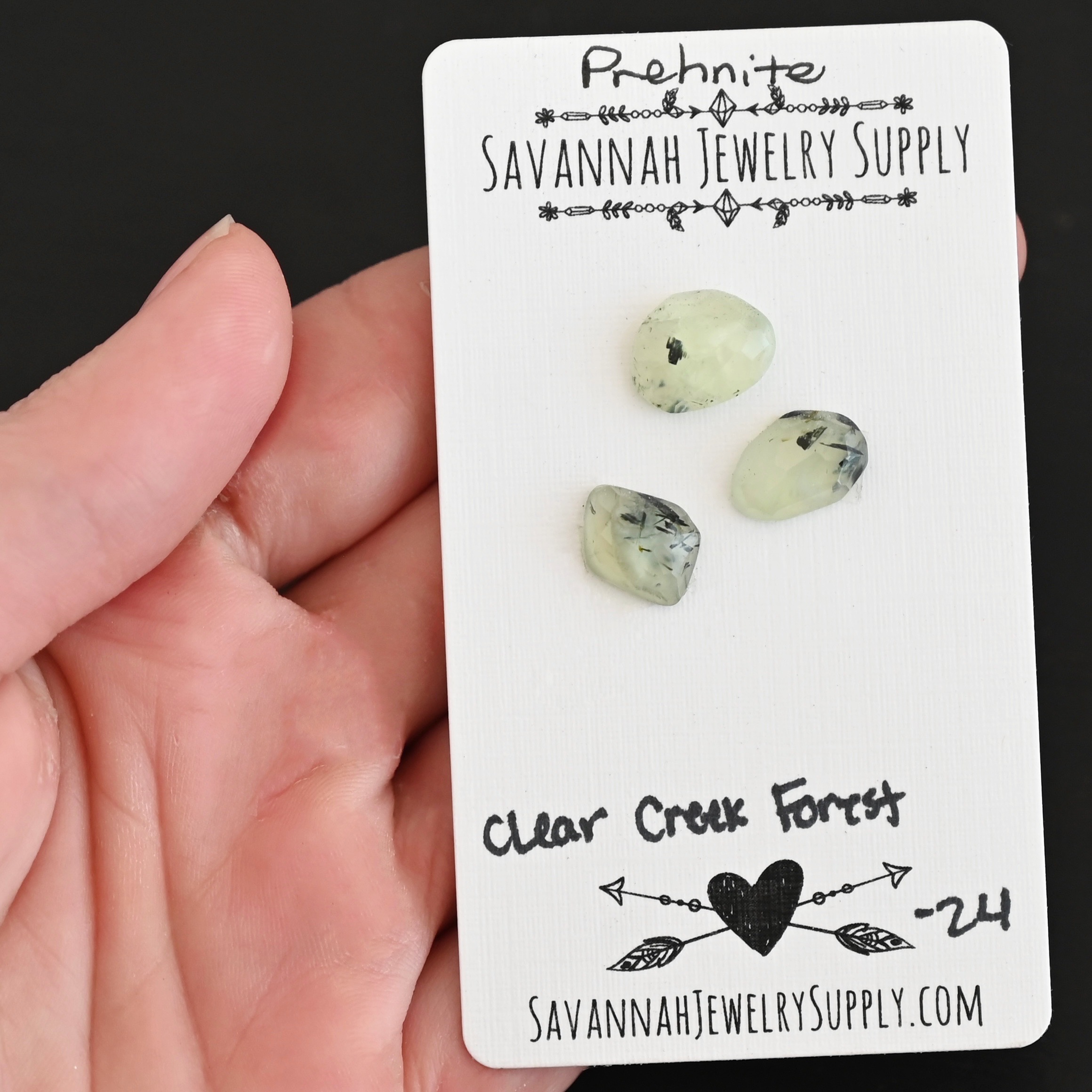 Clear Creek Forest Rose Cut Prehnite Cabochon Parcel shown in hand
