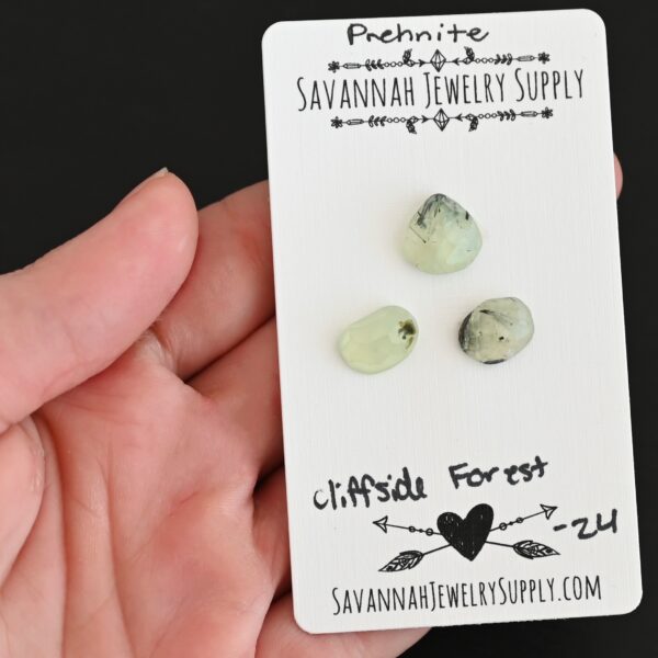 Cliffside Forest Rose Cut Prehnite Cabochon Parcel shown in hand