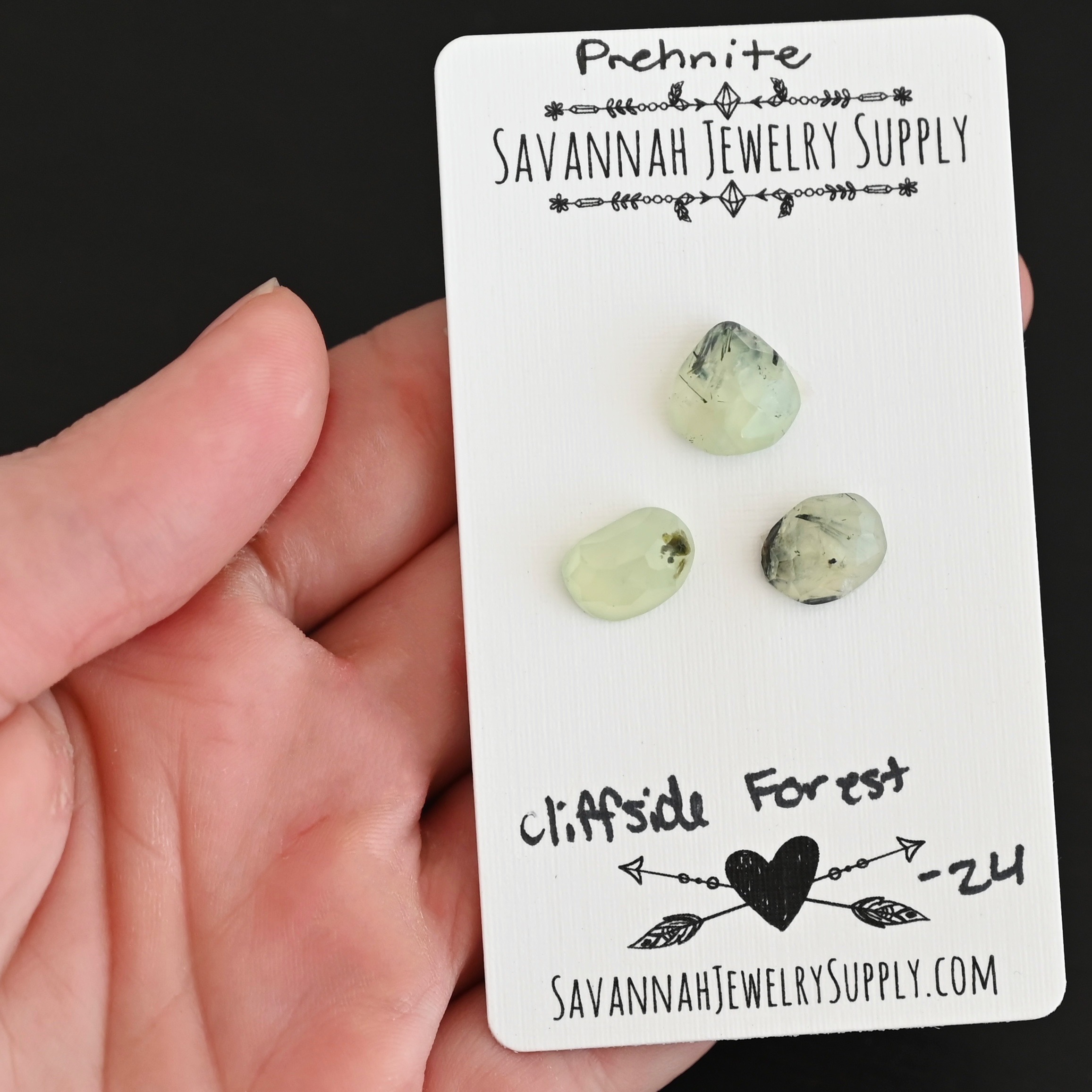 Cliffside Forest Rose Cut Prehnite Cabochon Parcel shown in hand