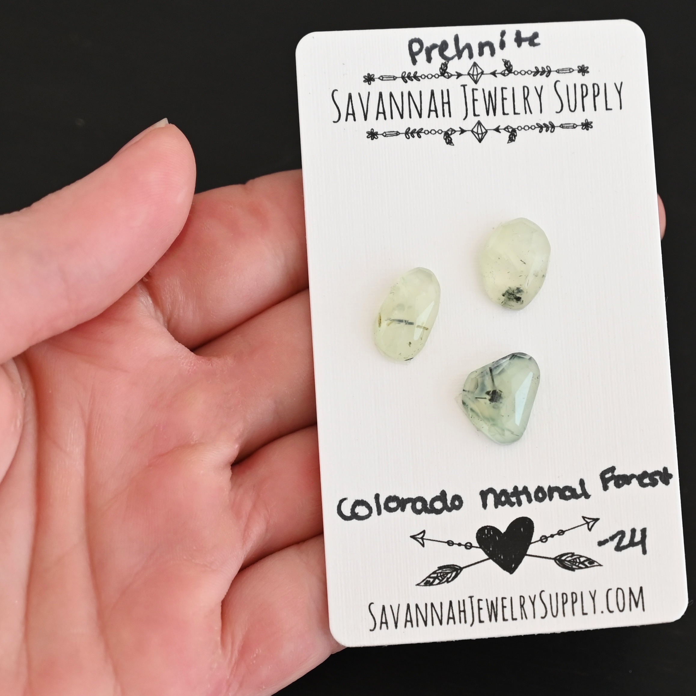 Colorado National Forest Rose Cut Prehnite Cabochon Parcel shown in hand