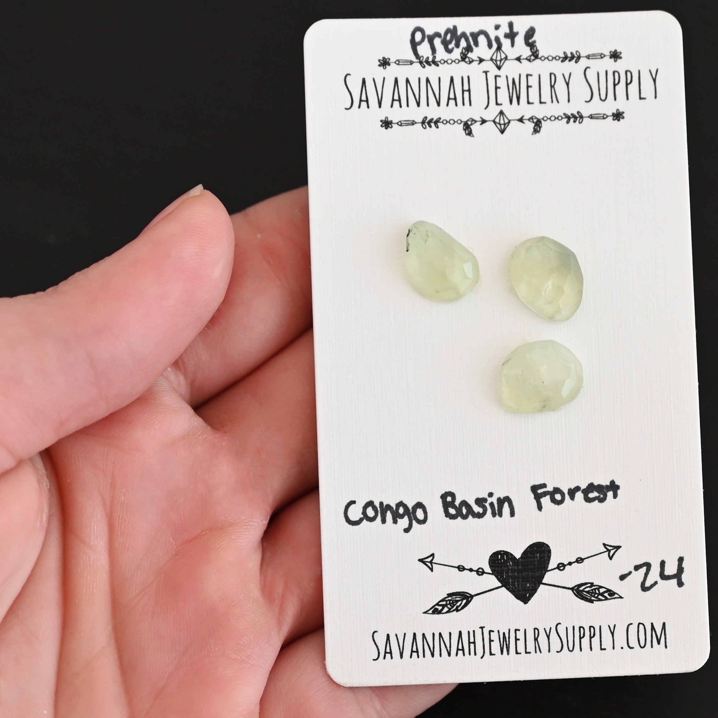 Congo Basin Forest Rose Cut Prehnite Cabochon Parcel shown in hand