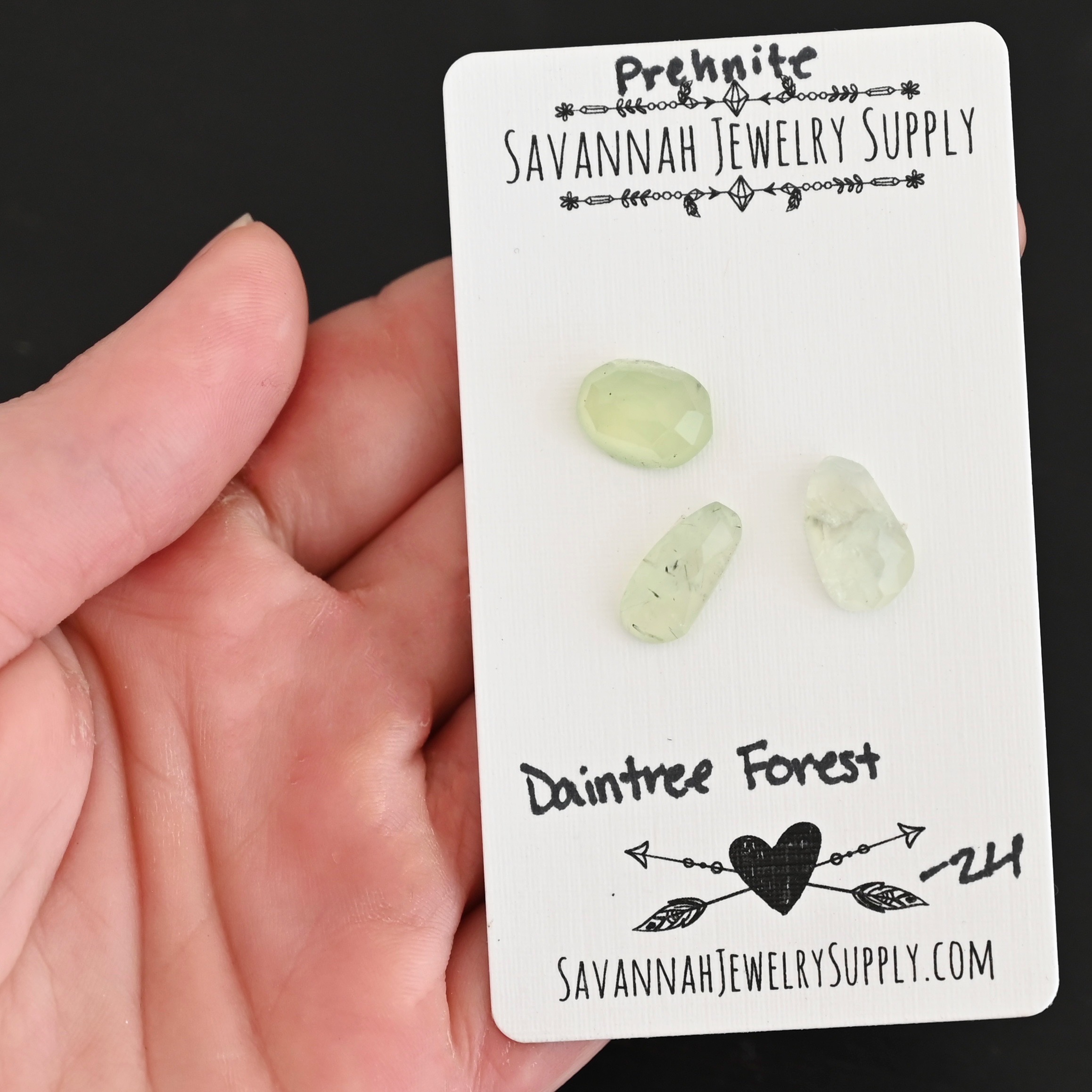 Daintree Forest Rose Cut Prehnite Cabochon Parcel shown in hand