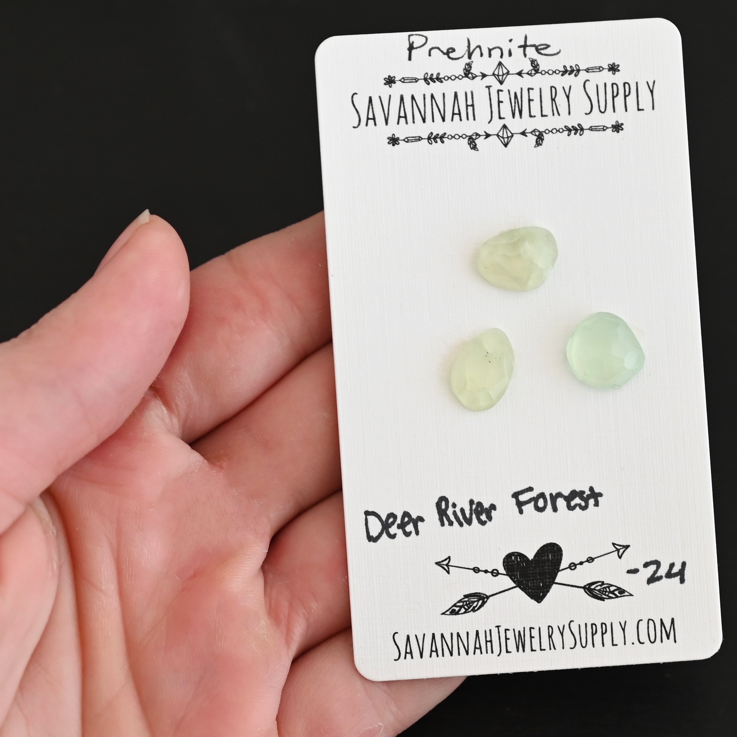 Deer River Forest Rose Cut Prehnite Cabochon Parcel shown in hand