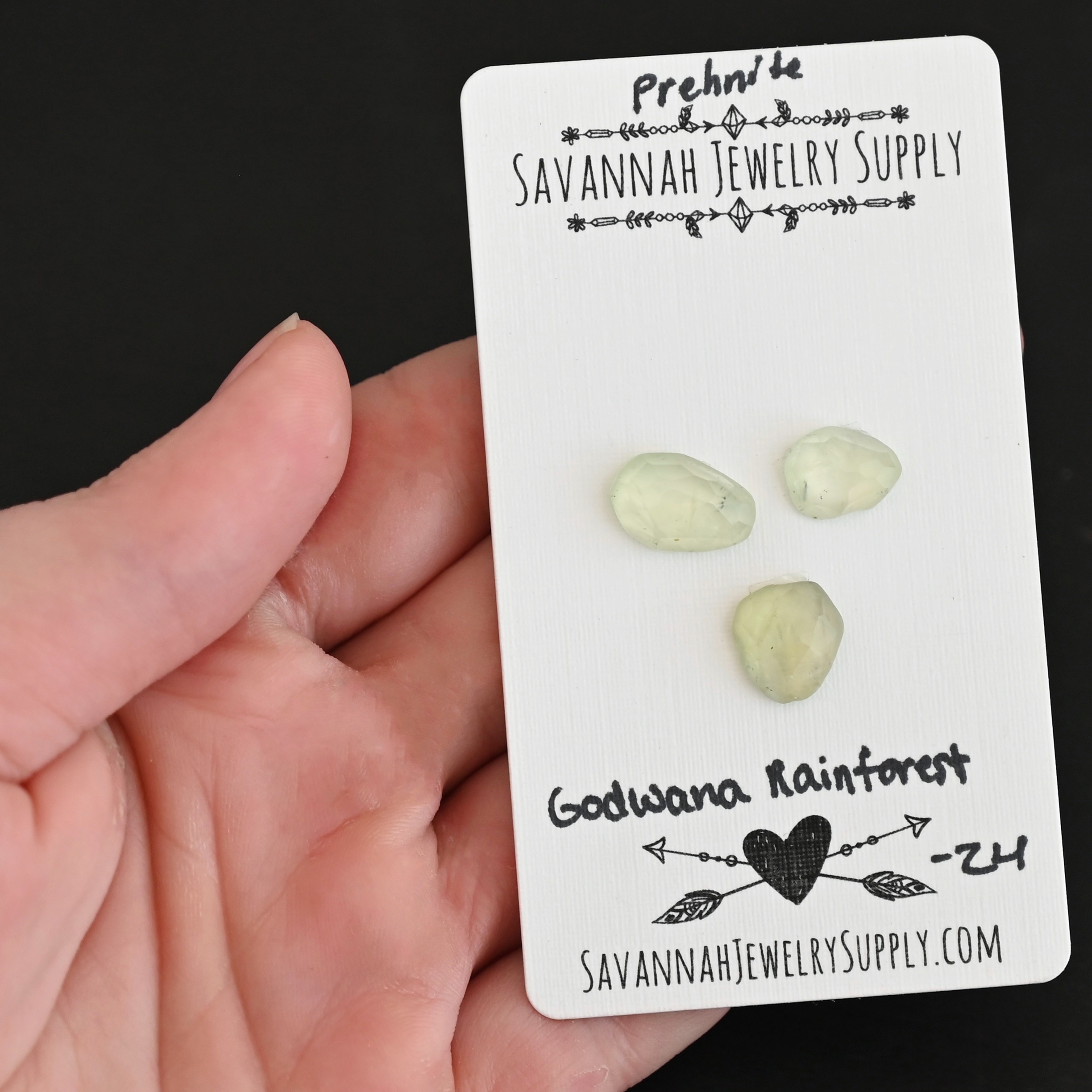 Gondwana RainForest Rose Cut Prehnite Cabochon Parcel shown in hand