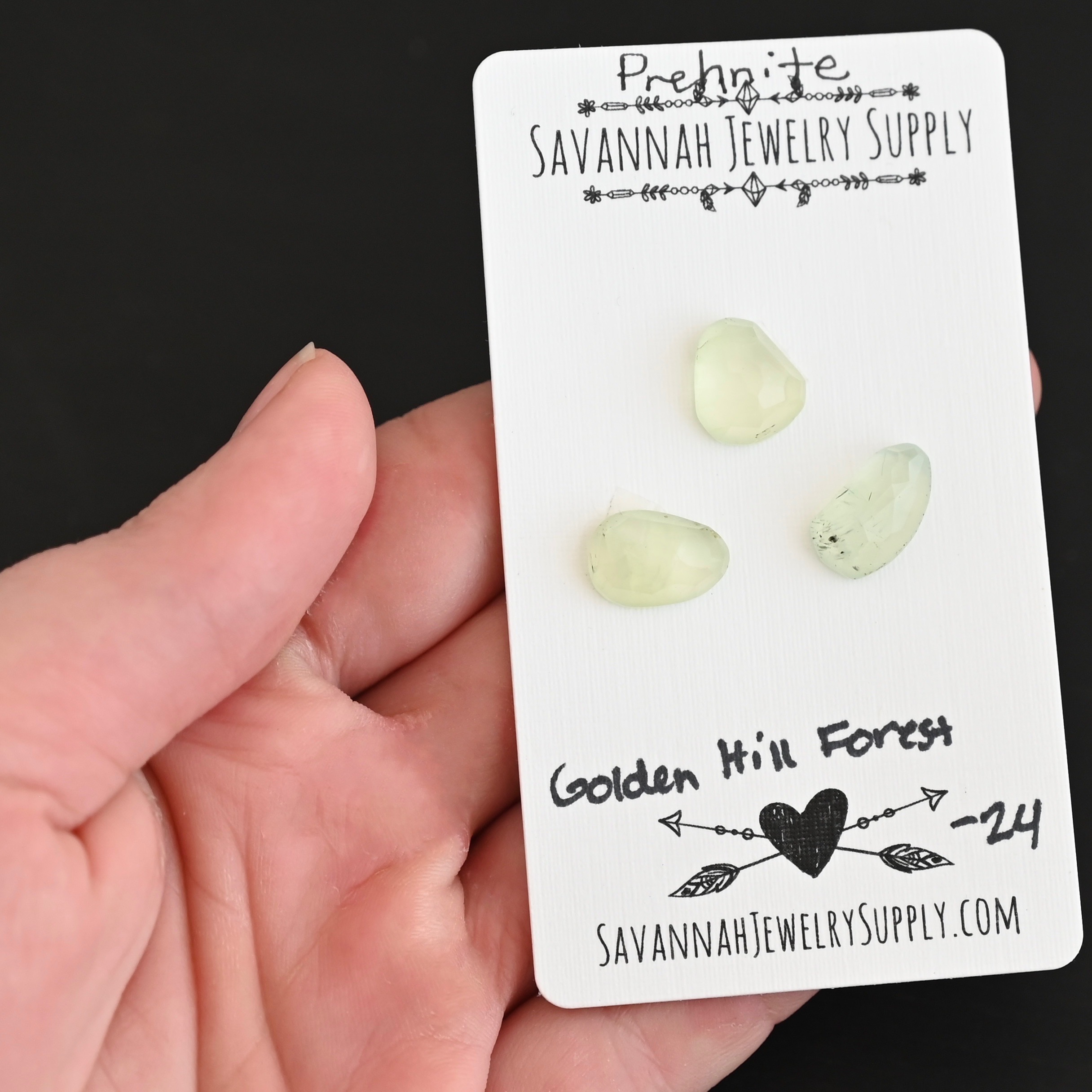 Golden Hill Forest Rose Cut Prehnite Cabochon Parcel shown in hand