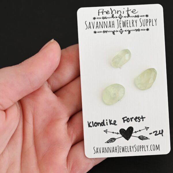 Klondike Forest Rose Cut Prehnite Cabochon Parcel shown in hand