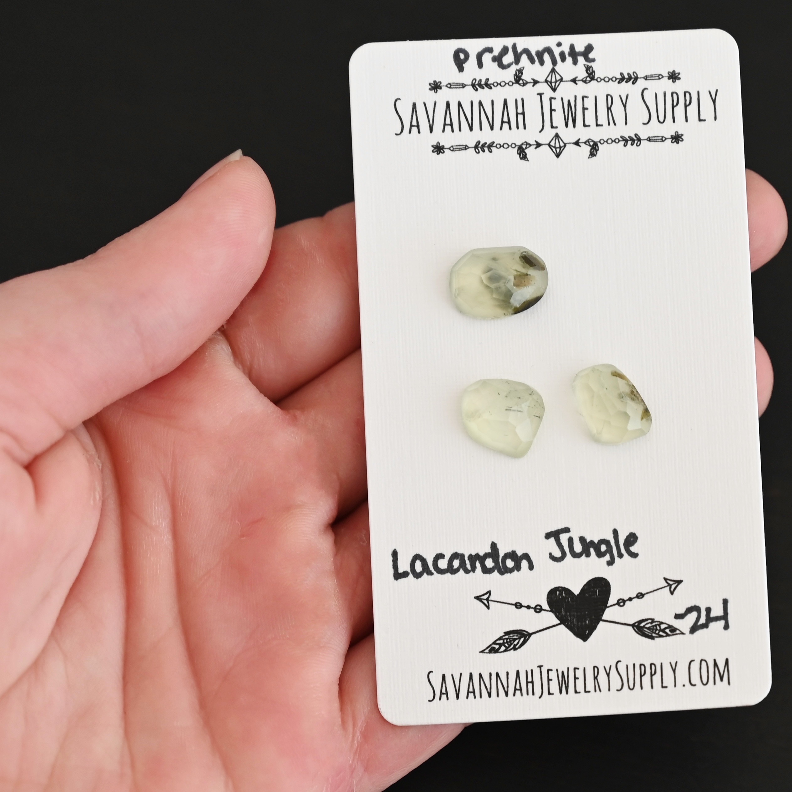 Lacadon Jungle Rose Cut Prehnite Cabochon Parcel shown in hand