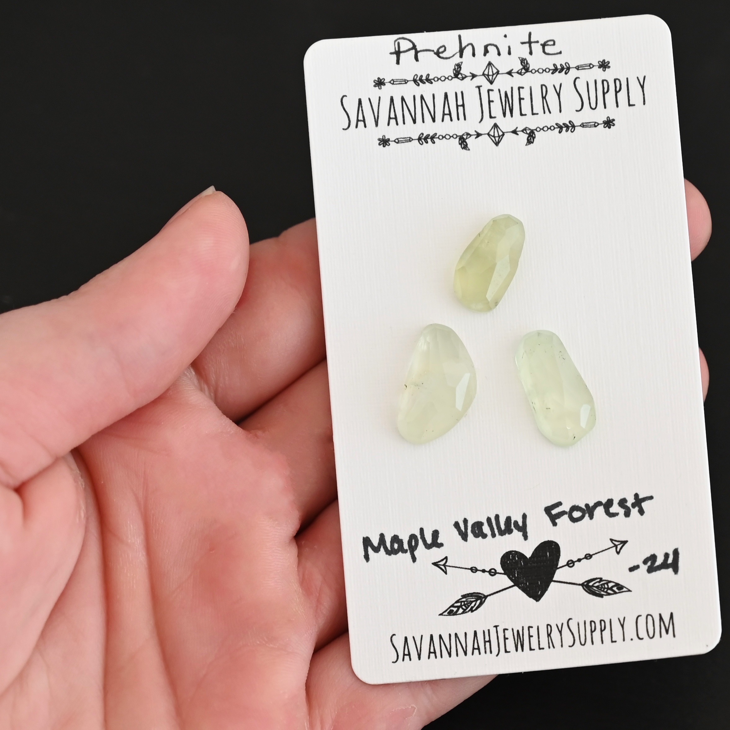 Maple Valley Forest Rose Cut Prehnite Cabochon Parcel shown in hand