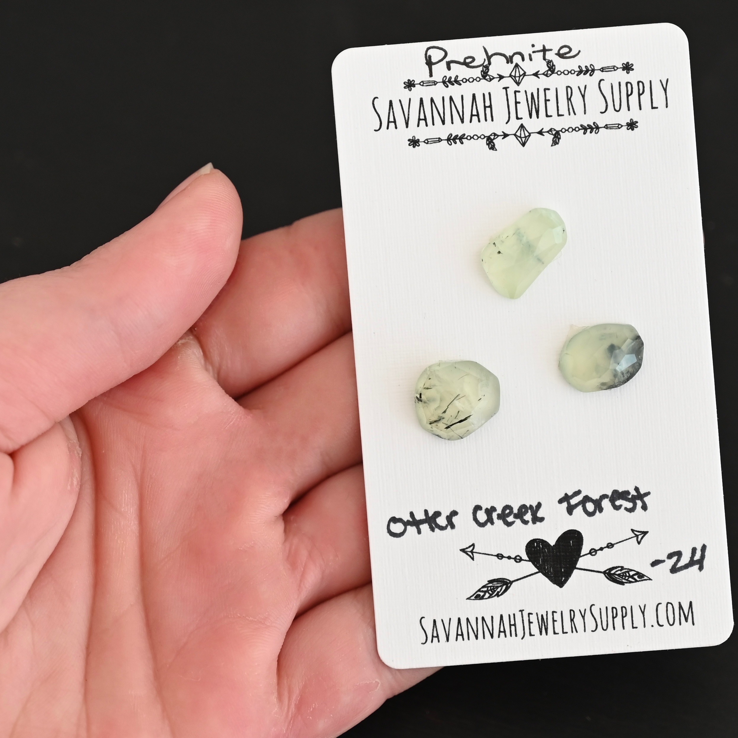 Otter Creek Forest Rose Cut Prehnite Cabochon Parcel shown in hand